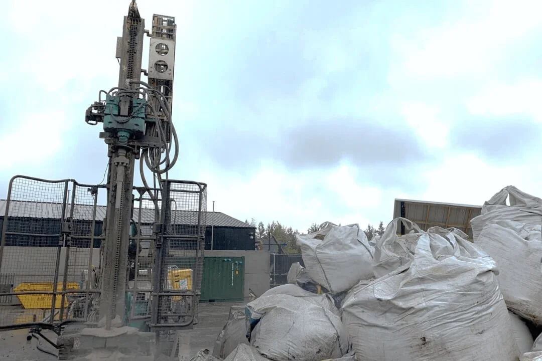 Drilling rig on construction site for intrusive ground investigation and geological assessment.
