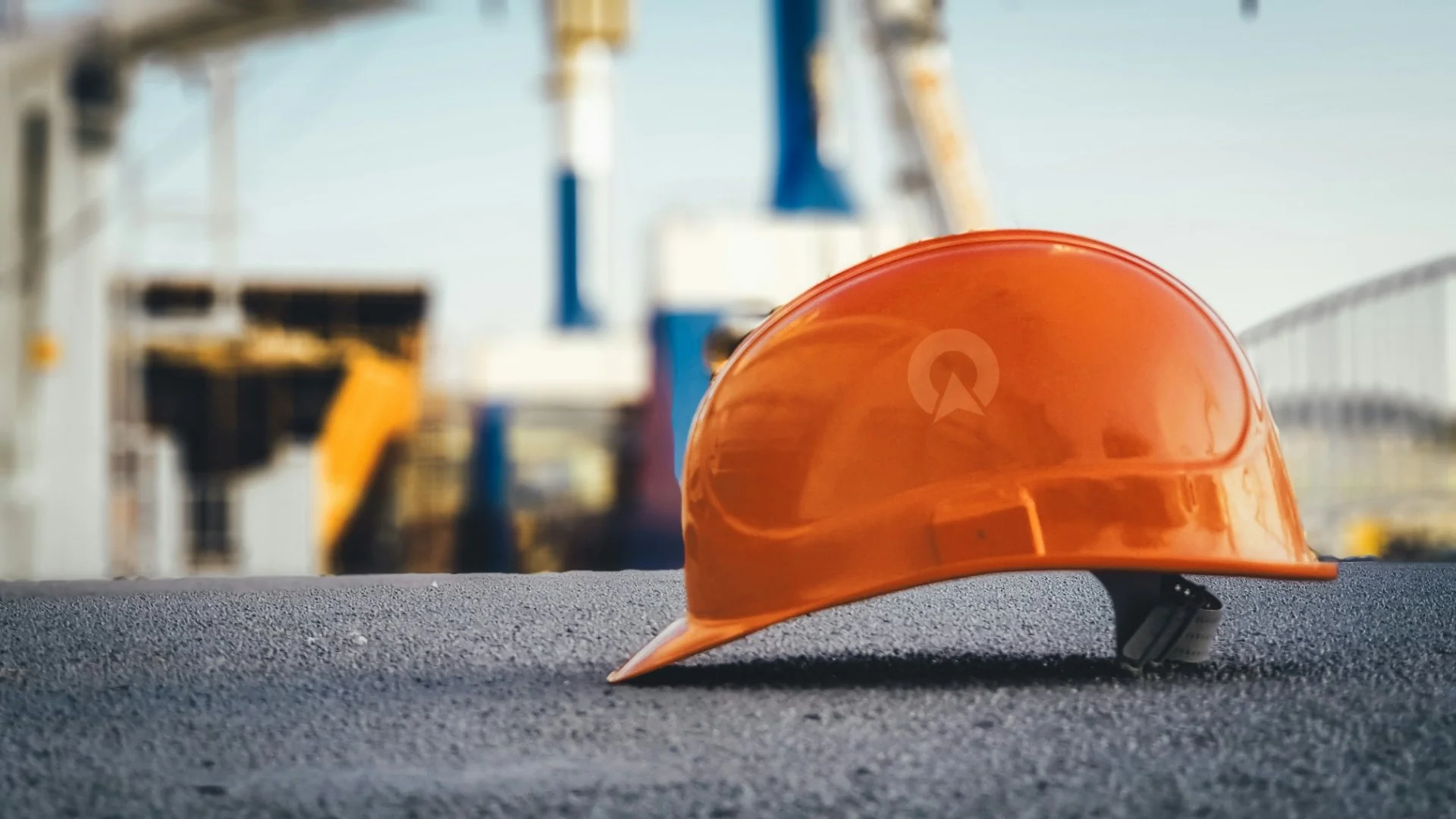 Orange safety helmet with Northpoint logo at a construction site, representing geotechnical engineering and ground investigation services in the UK.