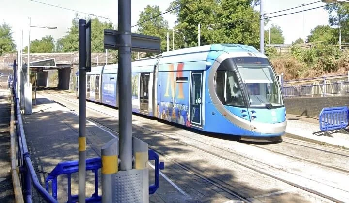 West Midlands Metro tram passing under Dudley Street Bridge in Birmingham during bridge upgrade works.
