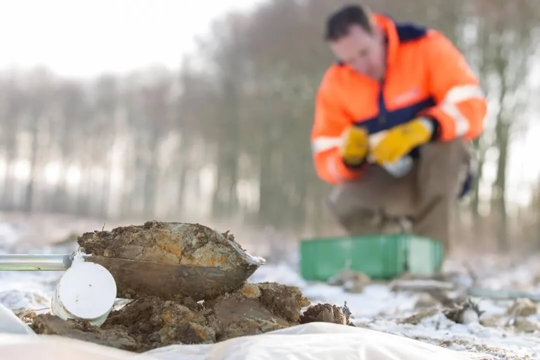 Soil sample collection in the field for Phase 2 geological investigation.