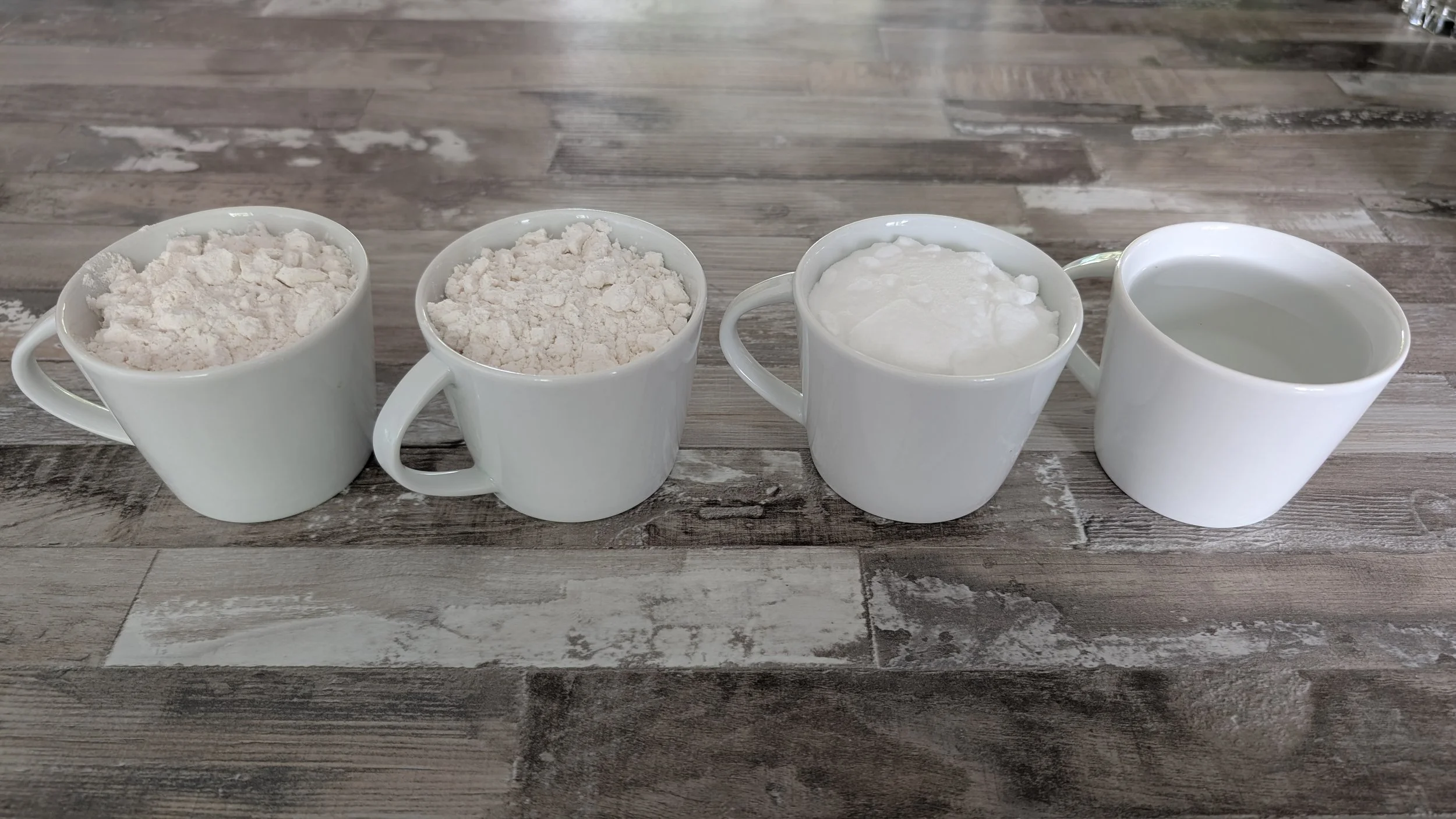 4 petites tasses contenant les ingrédients de la pâte à sel