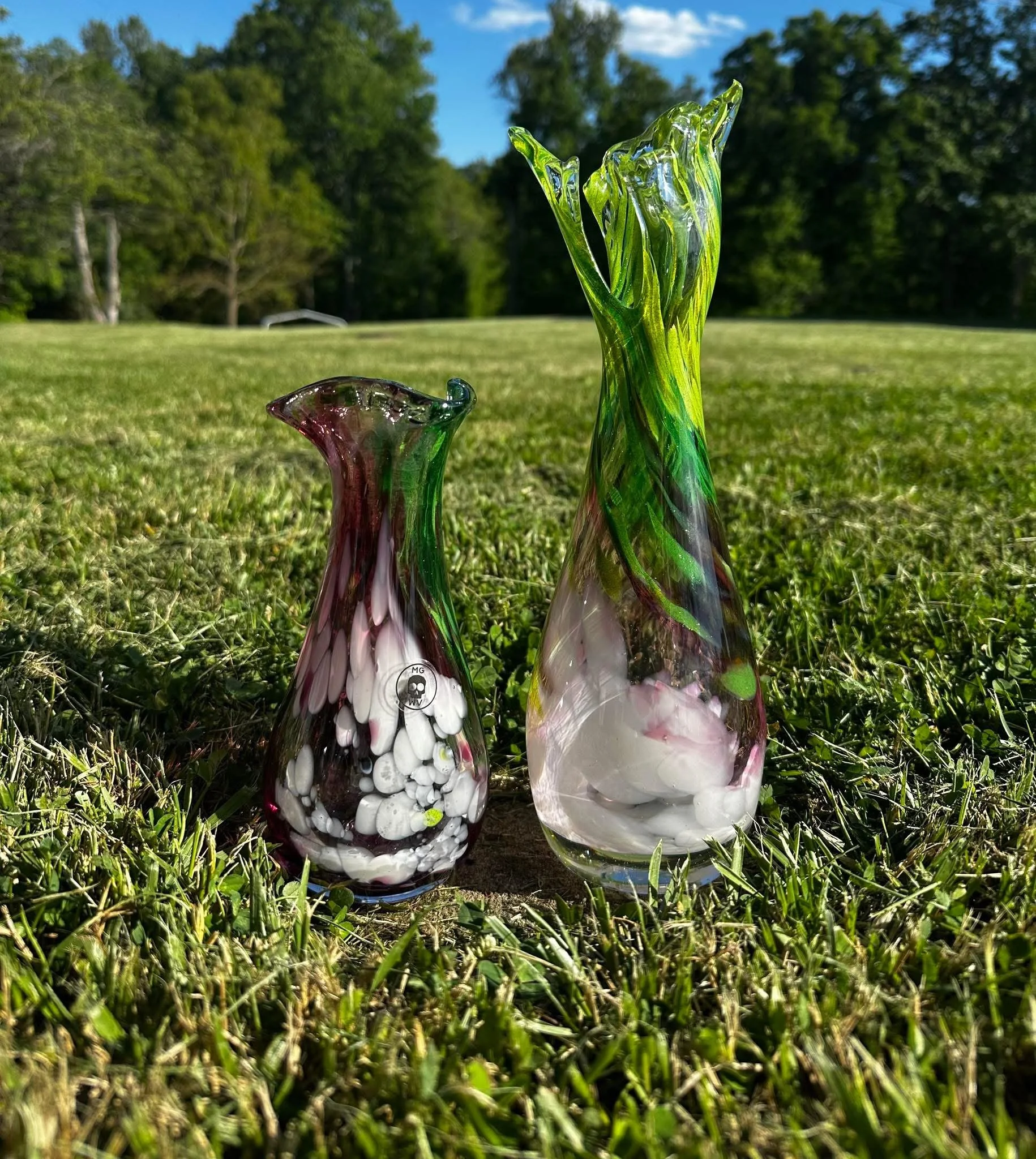 Ramp Vase and shorter variant of ramp vase sitting on bright green spring lawn in setting sun