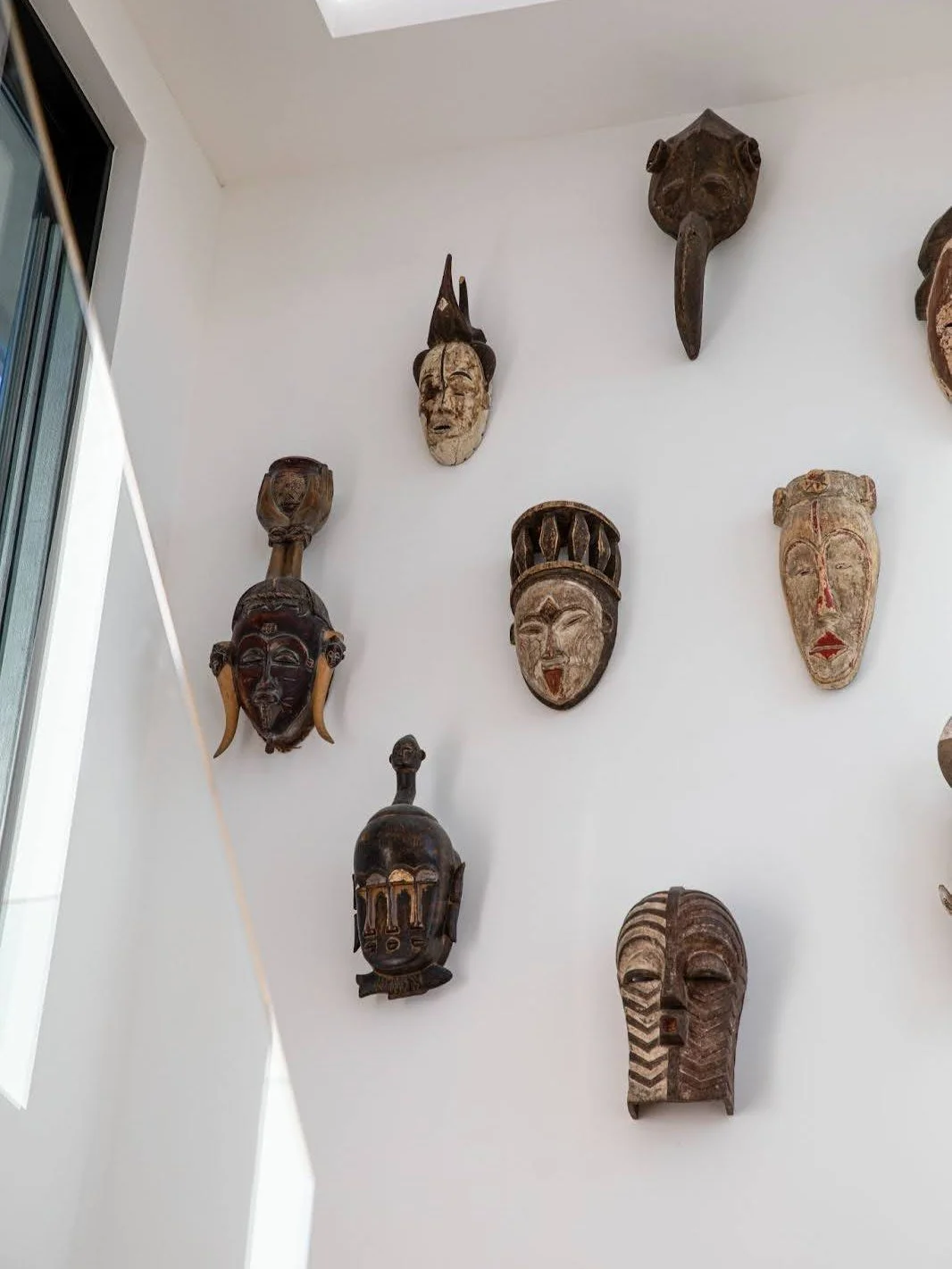 Blending personal story with design. Through the front door of this home is a staircase bathed in natural light from expansive skylights. The perfect backdrop for the clients&rsquo; curated collection of art and artifacts, reflecting their South Afri