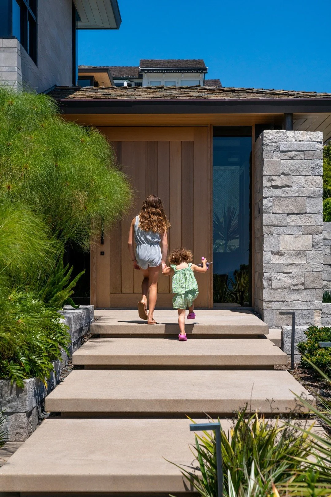 Stone cladding that echoes the nearby cliffs, this project is designed to feel grounded in its landscape. 

The lower floor walls knit the home to the earth, creating a strong foundation that supports the lighter, more transparent living spaces above