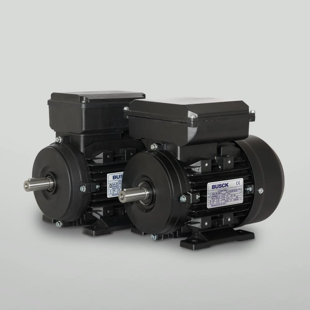 Two black industrial motors with metal shafts and labels, placed on a plain white background.