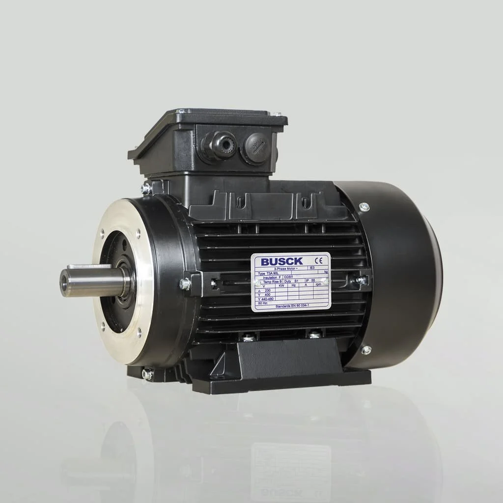 A black industrial electric motor with a metal shaft and cooling fins, mounted on a reflective surface against a plain background.