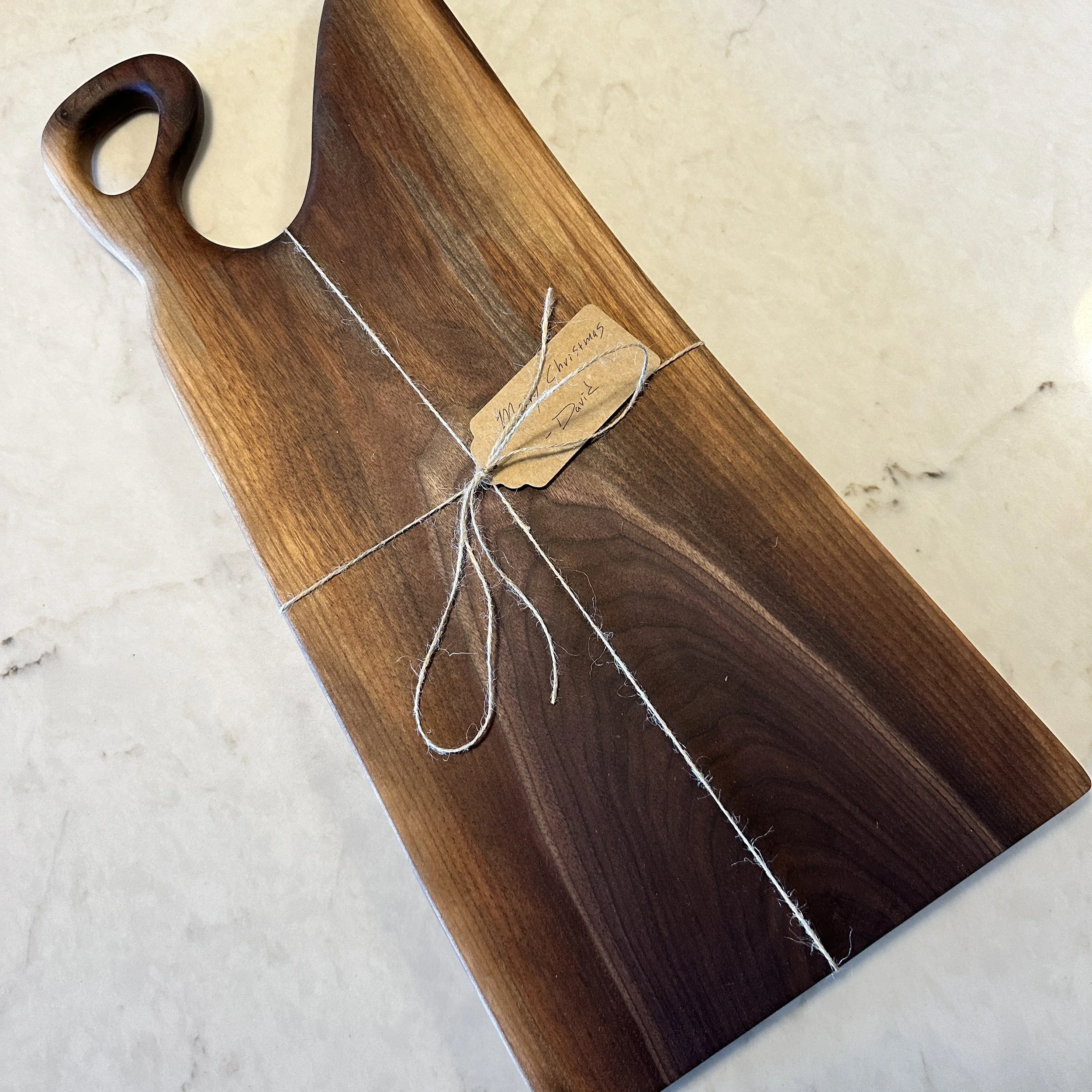 Live Edge Charcuterie board designed from Walnut with sap wood edges.