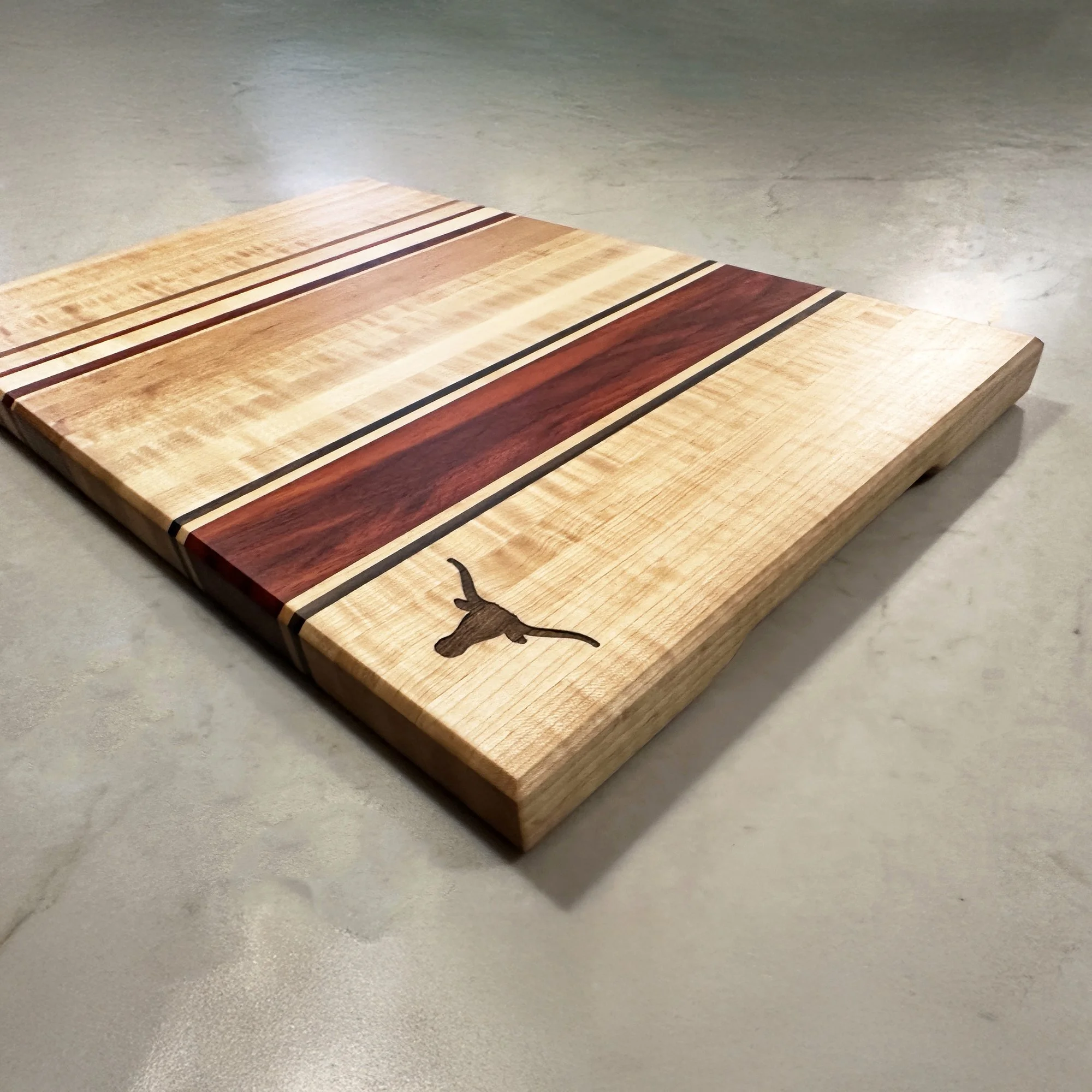 Large Hardwood Edge Grain cutting board with decorative stripes, featuring the Longhorn logo. - 22 x 14 x 1.25.