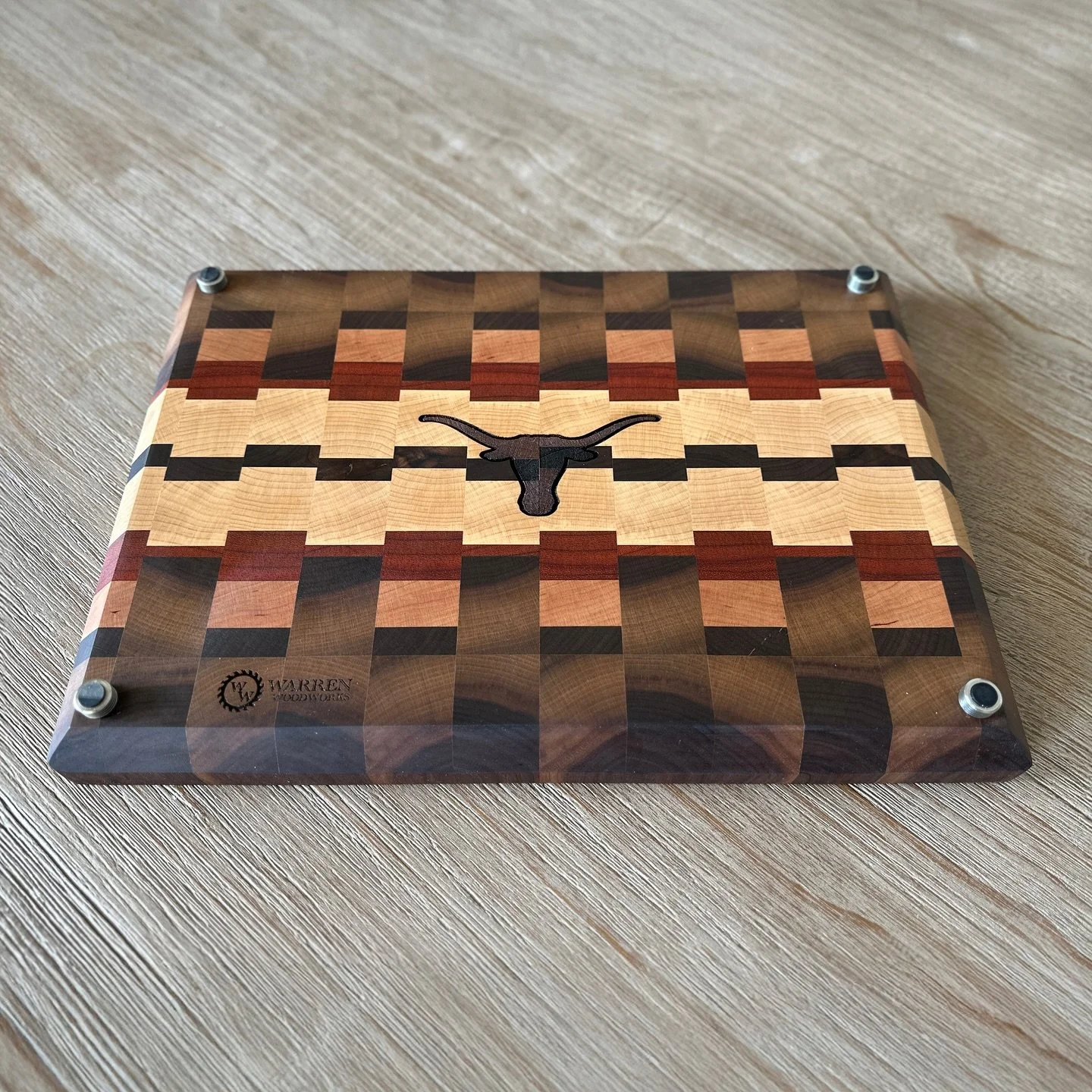 FOR SALE:  Hook ’em Horns 🤘
This handcrafted 15” x 10.75” end-grain cutting board is built from rich maple, walnut, and cherry hardwoods—highlighting the University of Texas Longhorn logo on the bottom. Durable, functional, a