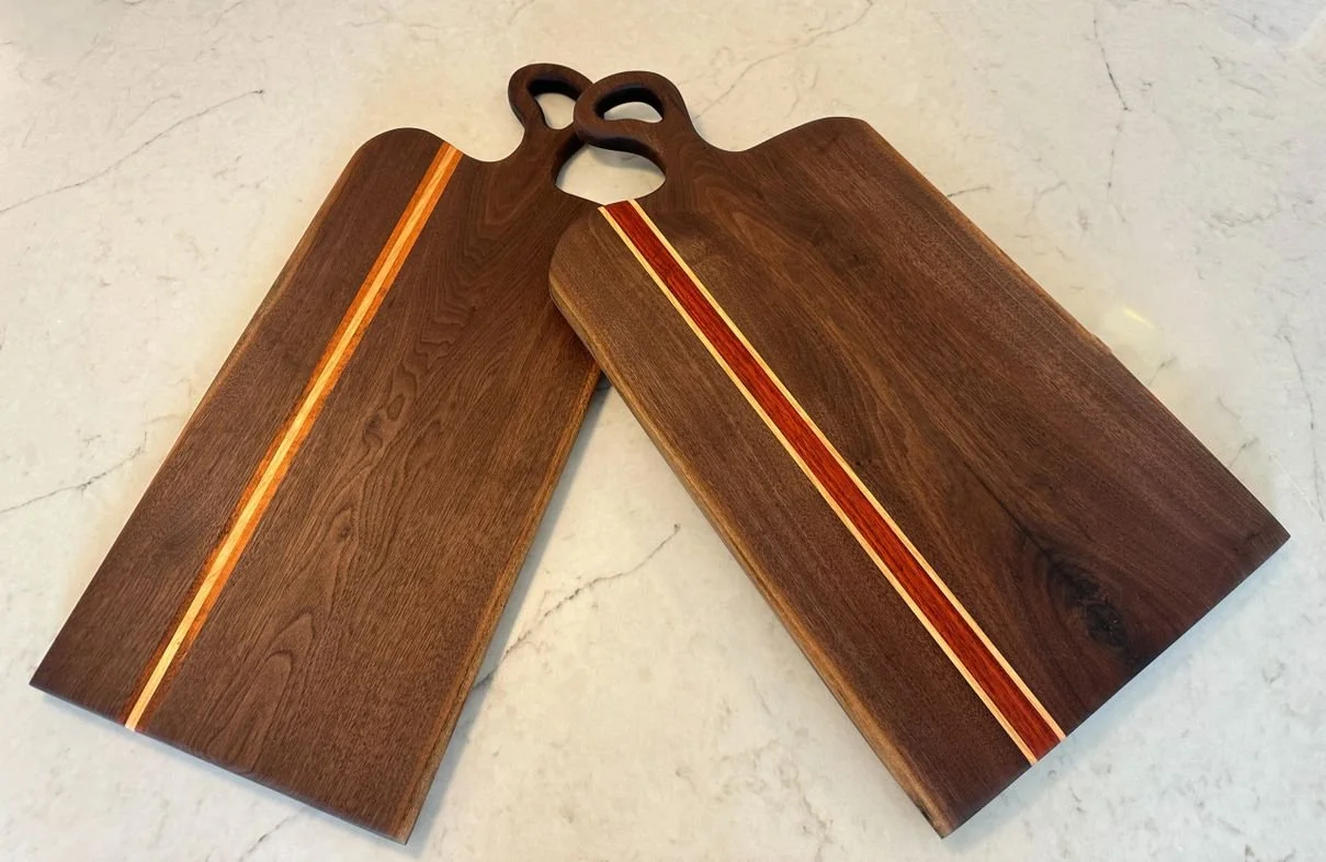 Large Charcuterie boards designed from Walnut with various harwood accents.