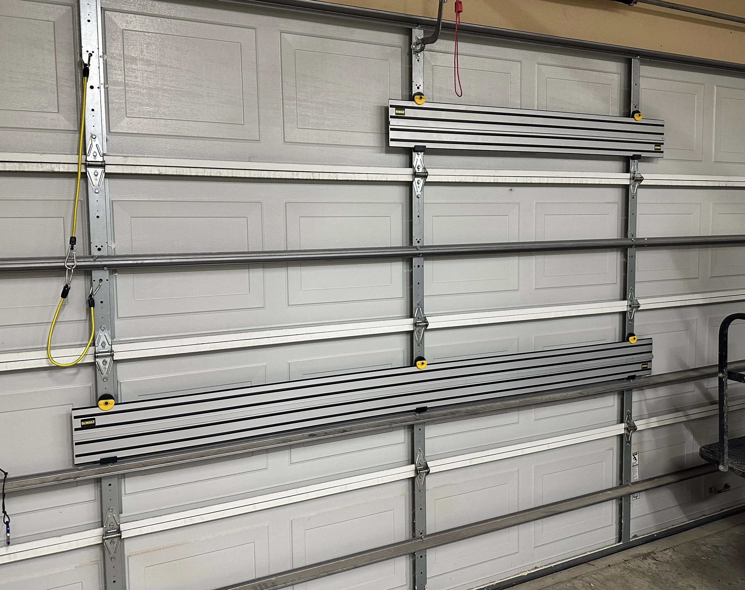 Dewalt 52" and 102" Track mounted to garage door for storage.