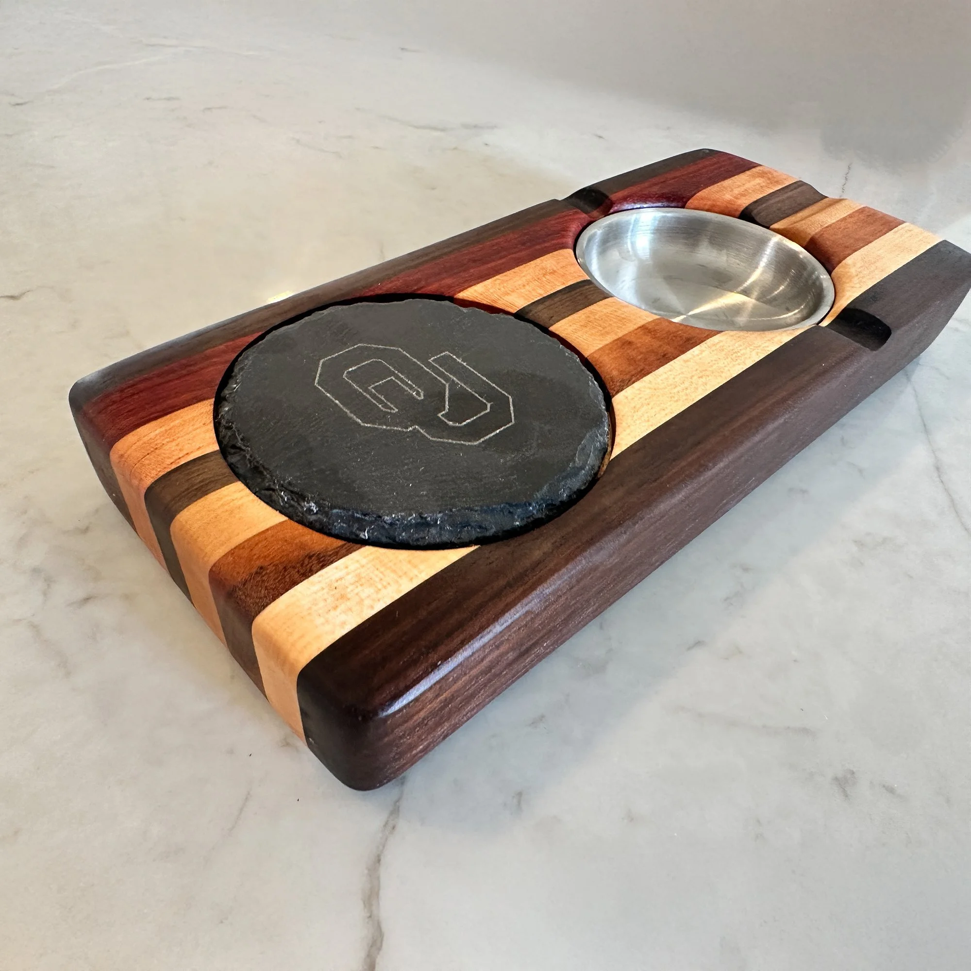 Cigar center branded with the OU logo with a slate coaster insert for your favorite beverage.