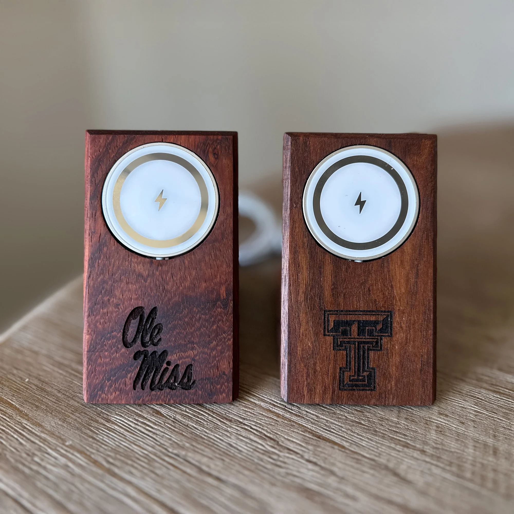 Three Wooden MagSafe Phone Chargers that make great graduation gifts. Featuring the Ol Miss and Texas Tech logos.