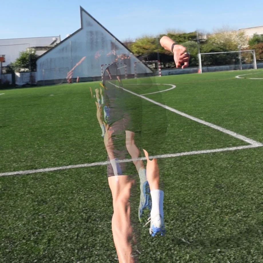 person running on a football field, seen through a shiny, curved surface. Sprinting on a training field.