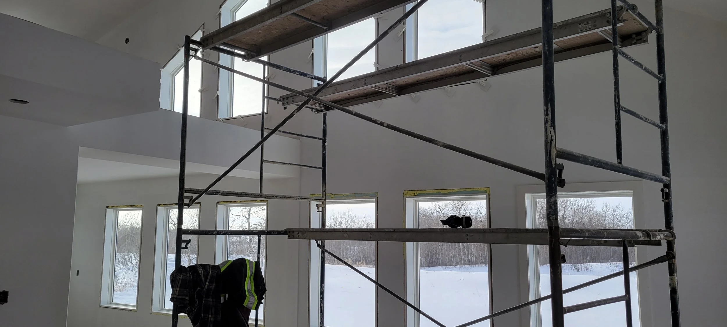 Window wall with rakehead windows finished with PVC Window Jamb Extensions