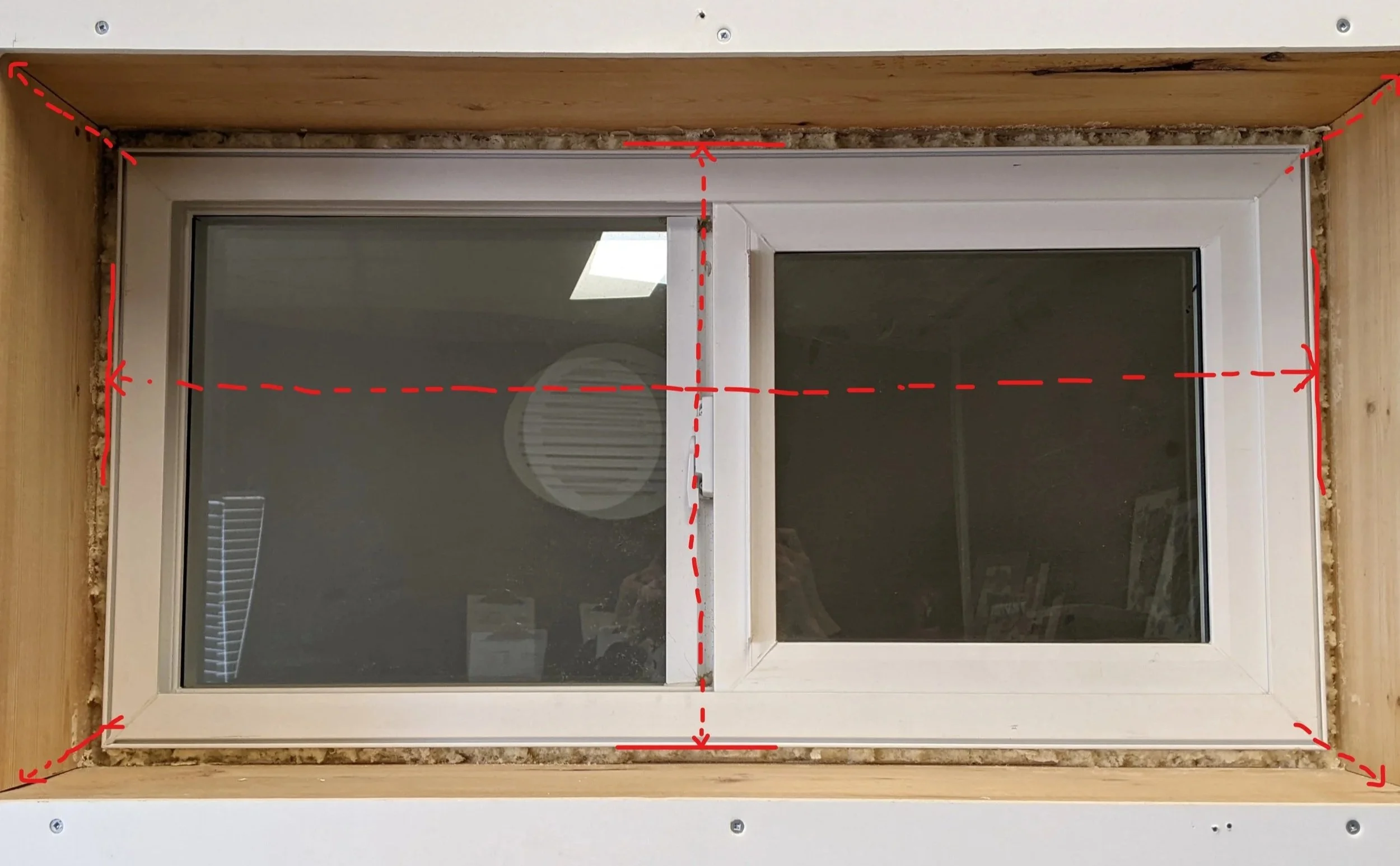 Close-up view of a double-pane window that needs a window jamb extension. Markings show where to take measurements on a window to order a PVC Window Jamb Extension.