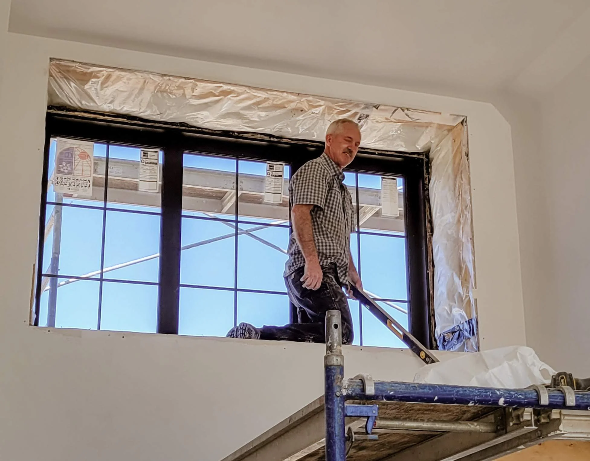 Ray at Trim Rite Mfg. finishing a large window with PVC