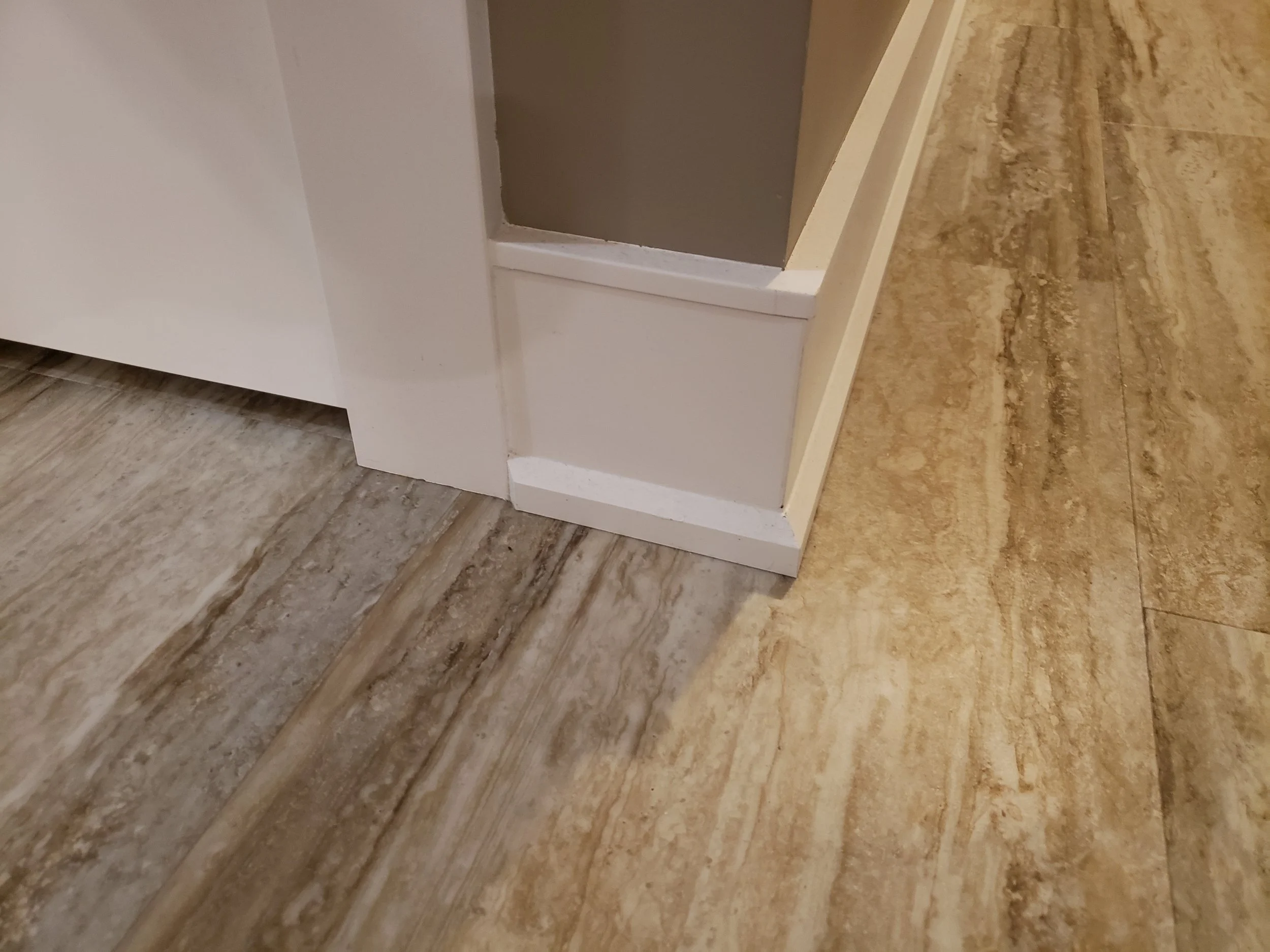 Close up of a wall finished with custom PVC Baseboard by Trim Rite Mfg.