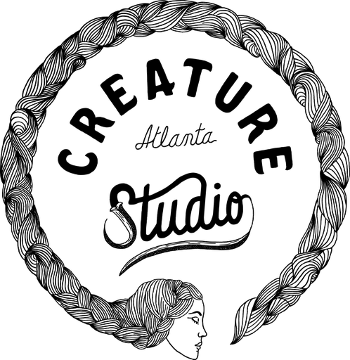 Logo of a creative studio featuring a circular rope border with a woman's face at the bottom, and the words "CREATURE Studio ATLANTA" inside.