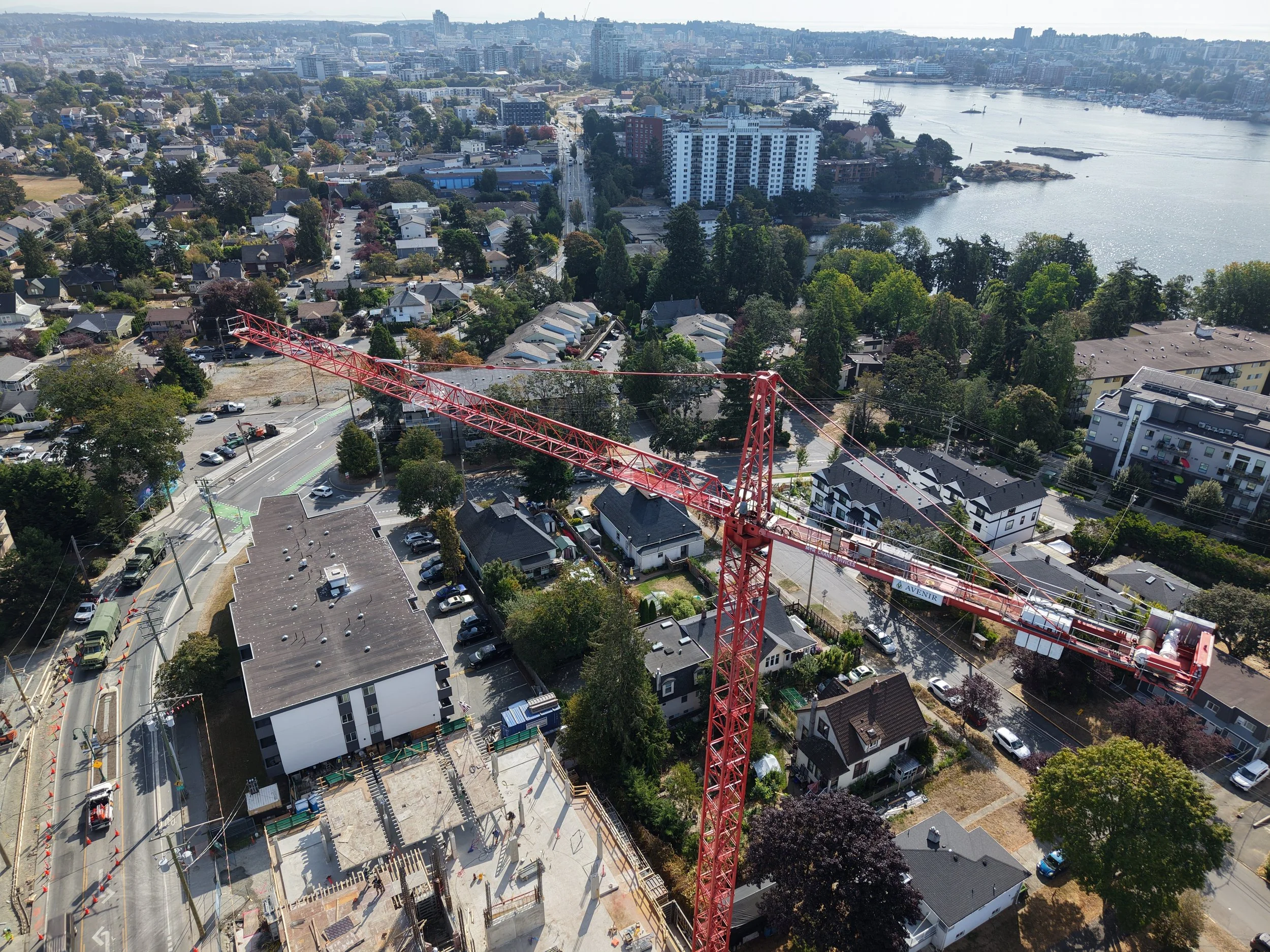 Aerial view of the Horizon construction project in Victoria, with a red tower crane rising above the active site and surrounding neighbourhood.