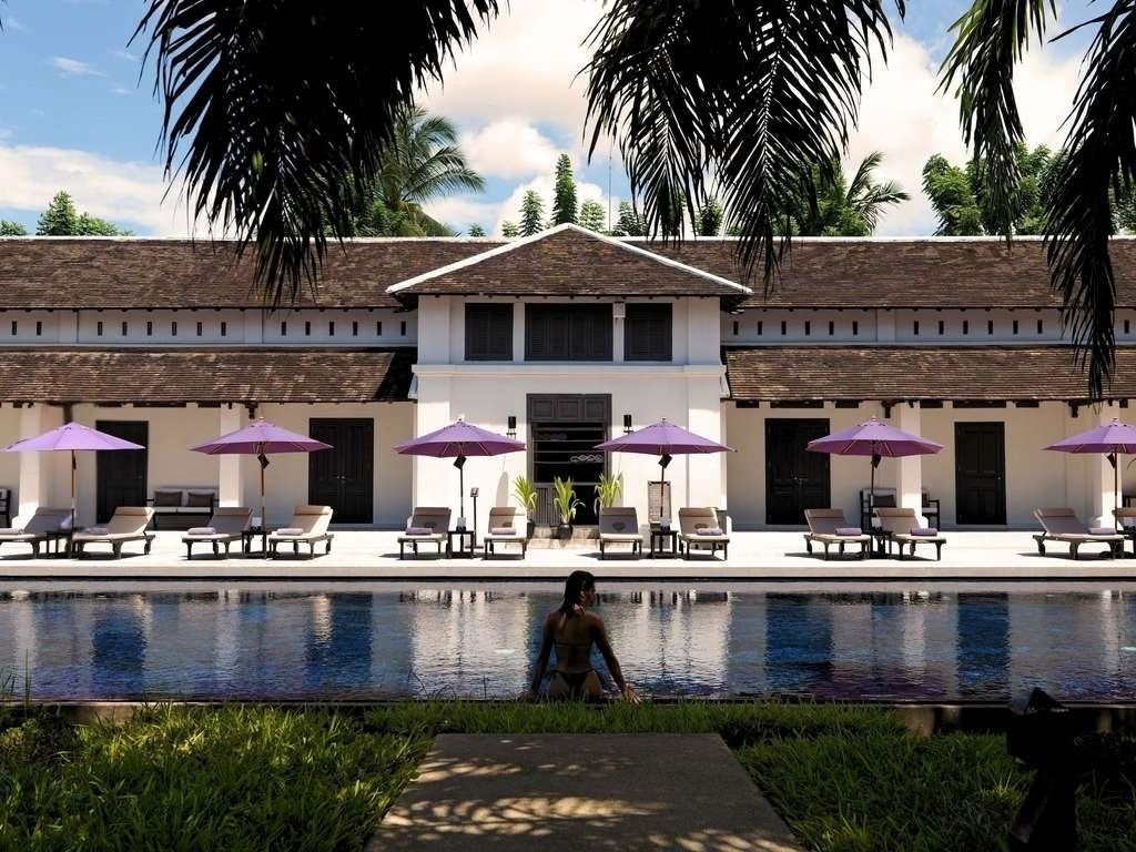 Sofitel Luang Prabang luxury resort with red-roofed villas, mountain views, and tropical gardens.
