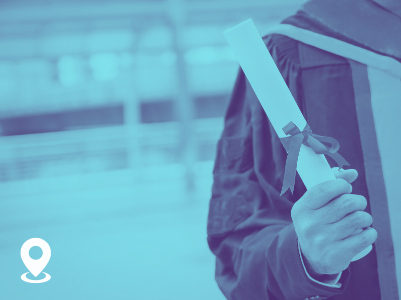 Person holding a rolled diploma with a ribbon, wearing a backpack indoors.
