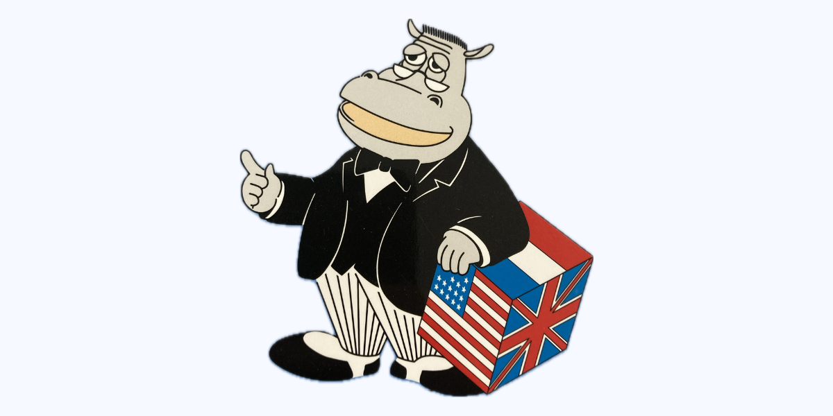 Cartoon hippopotamus wearing a tuxedo holding a box decorated with American and British flags, giving a thumbs-up.