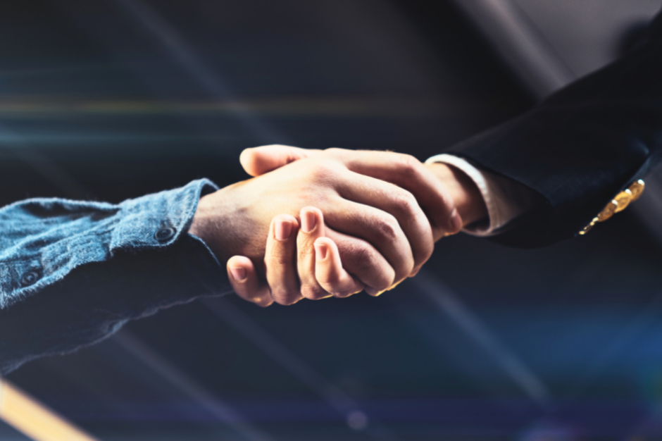 Cropped image of handshake between two people in a business deal.