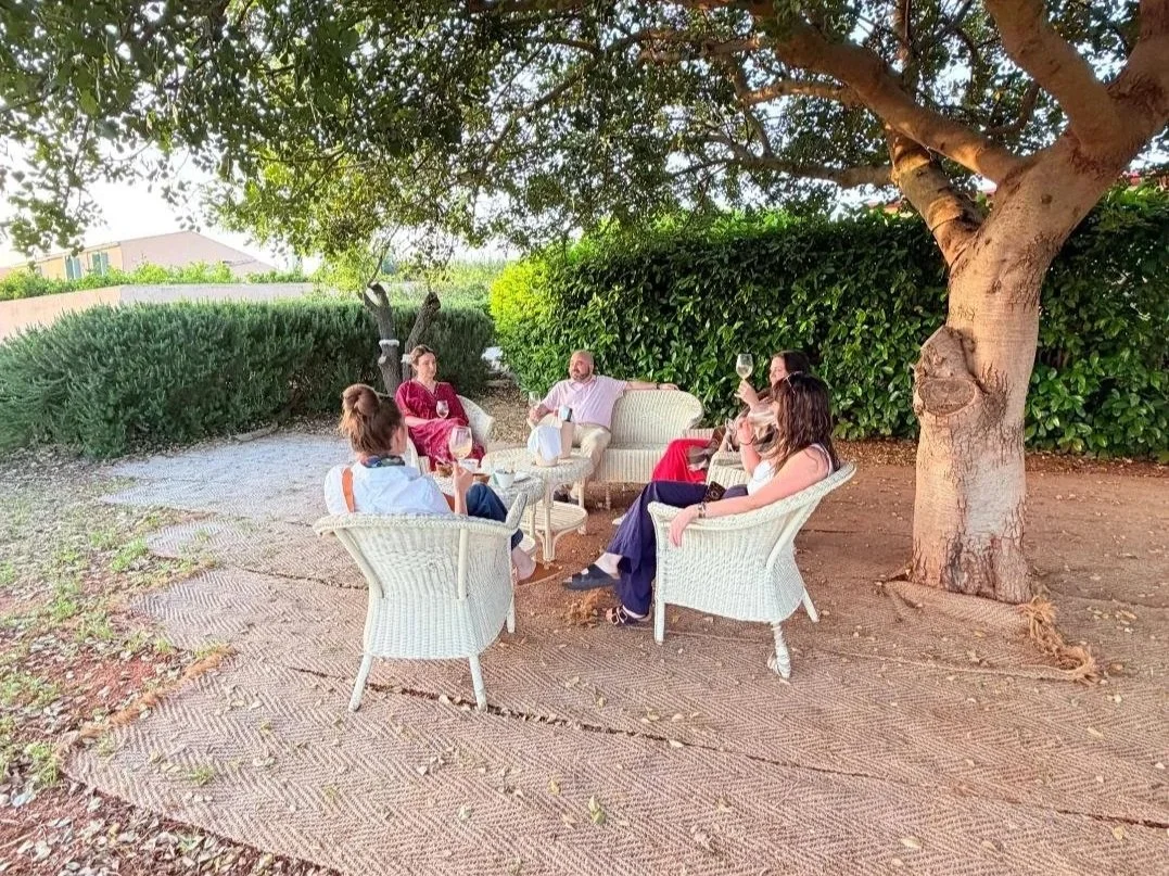 Sicily_GroupGathering_WhiteChairs_AncientTree.jpg