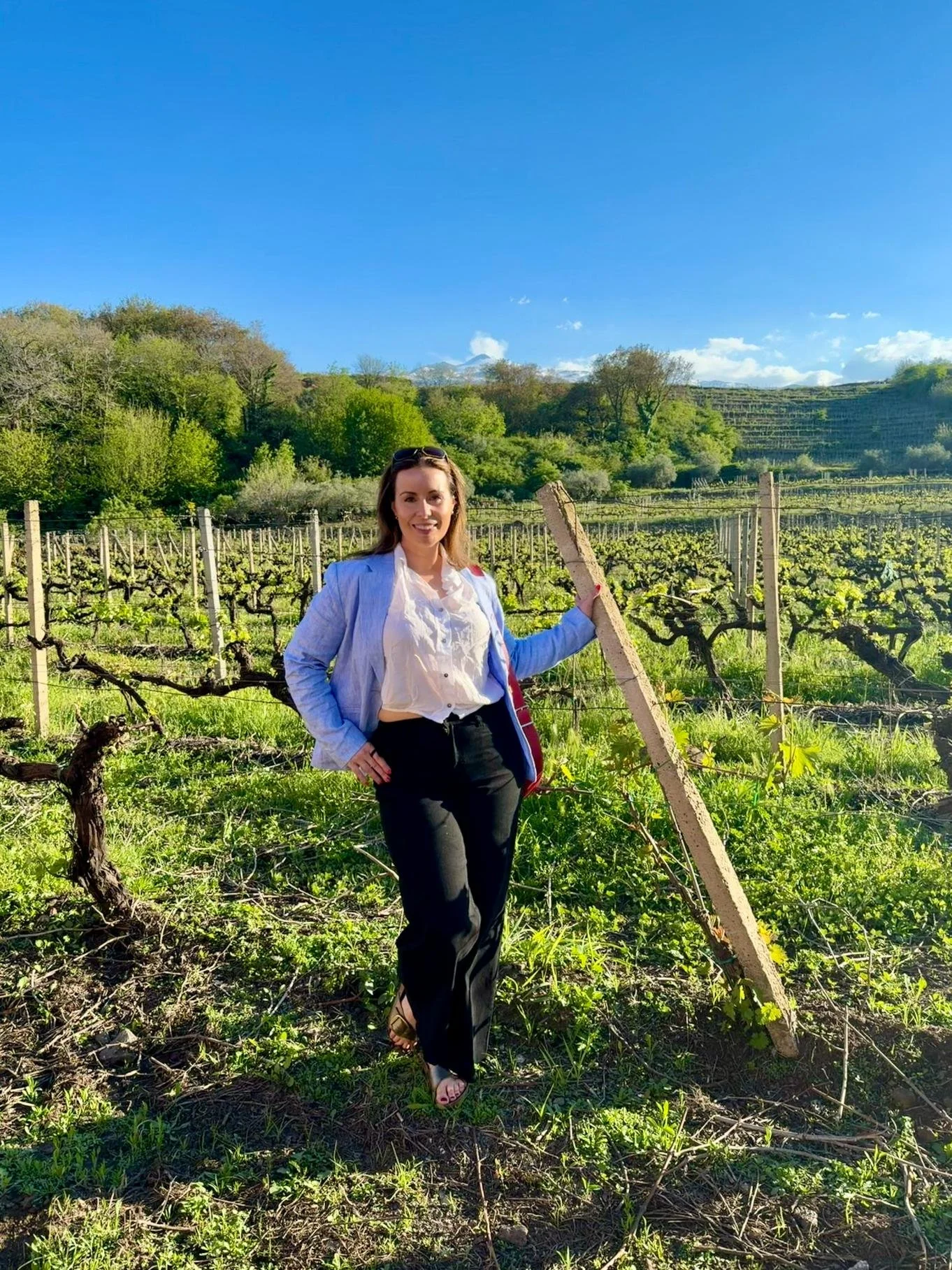 Image of Antonina standing in front of a vineyard