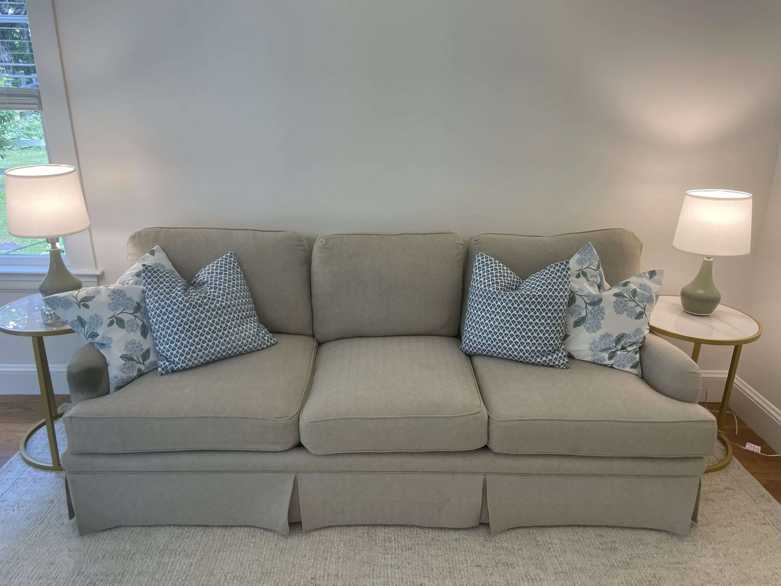 Couch with cozy cushions and lamps Elizabeth Cottage Historic Lakefront Vacation Home Belgrade Lakes Maine.jpg