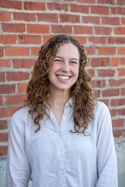 Karissa Sauder portrait in front of brick wall.