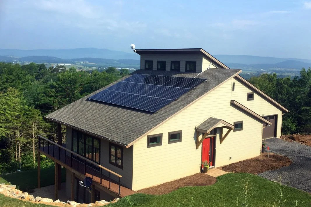 Net zero house with solar panels overlooking the mountains.