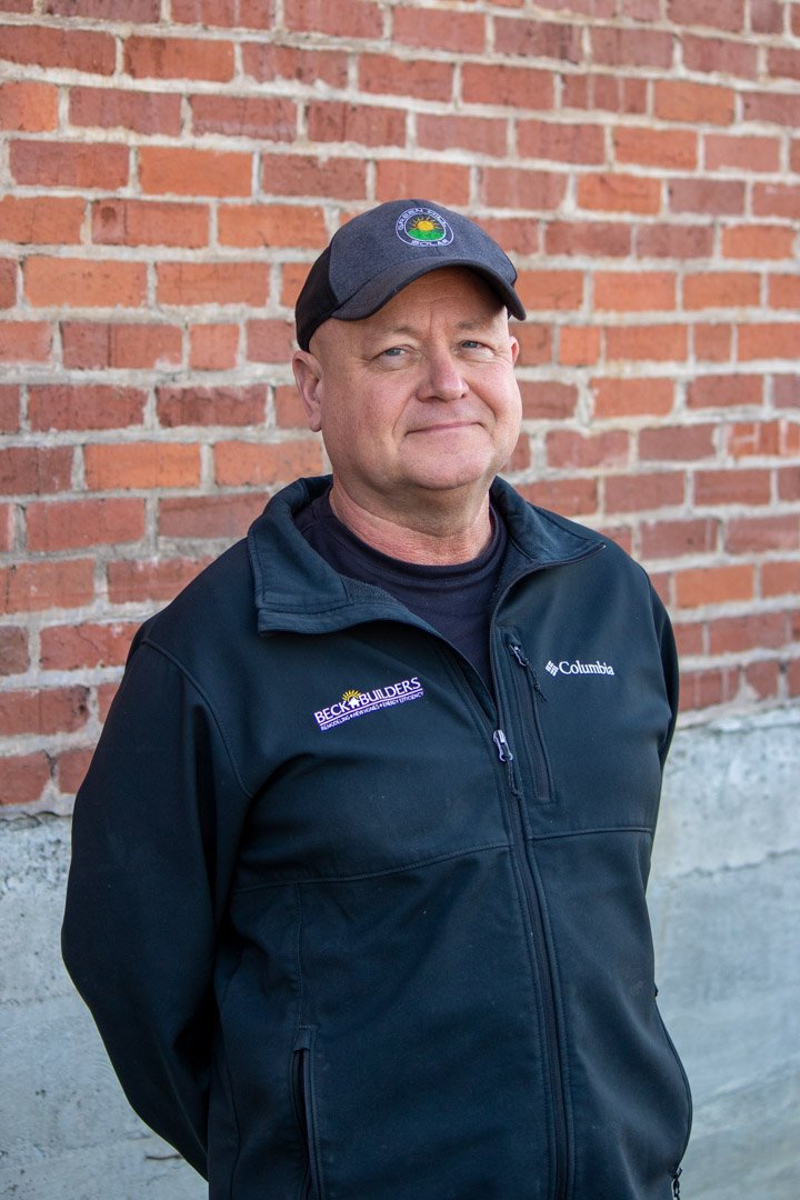 Brent Yoder portrait in front of brick wall.