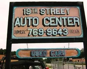Sign for 19th Street Auto Center advertising used cars, with phone number 769-9643