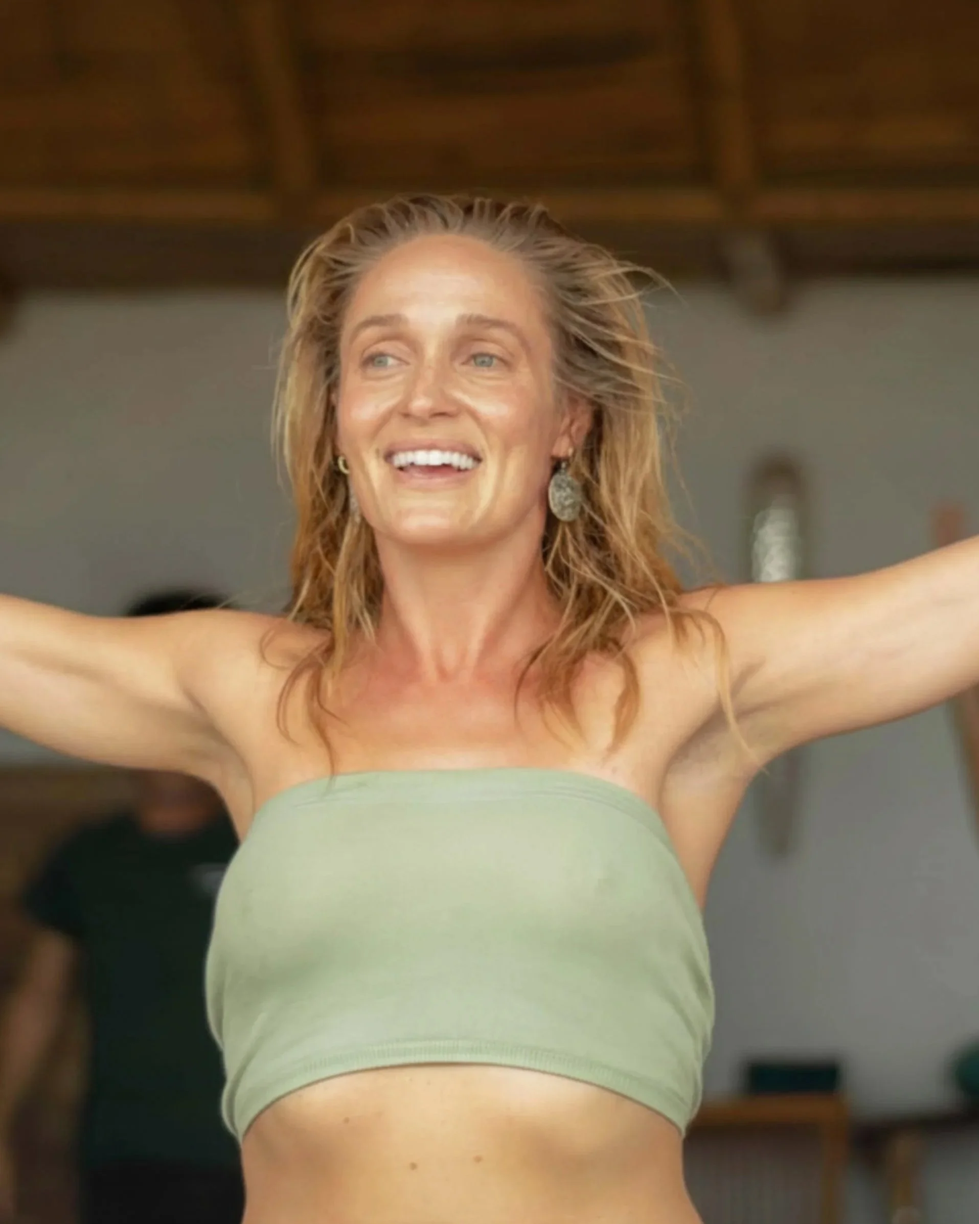 A woman doing yoga after surf