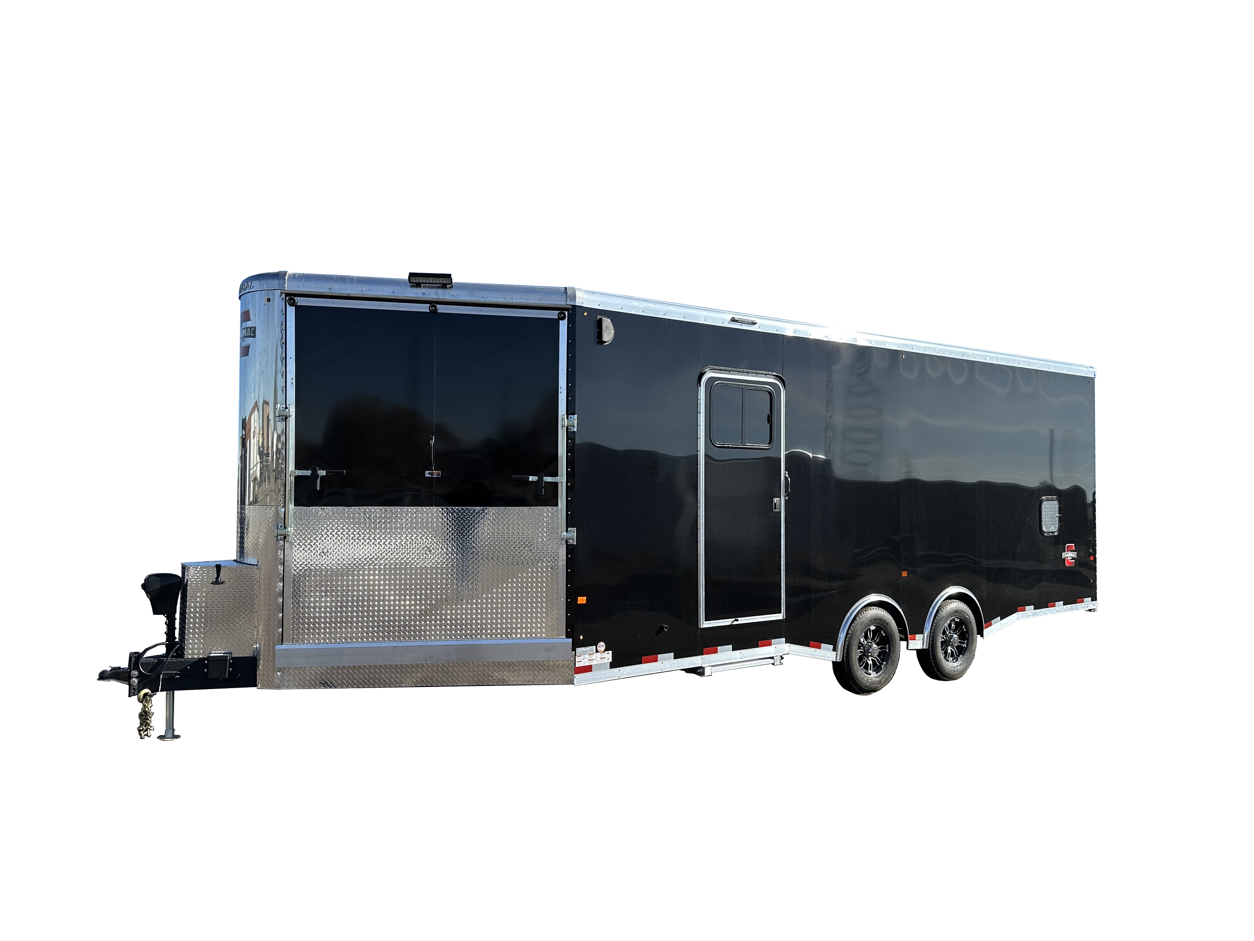 Black enclosed Charmac trailer with dual axles, a side door, and a large rear door, featuring metal accents and a wheel lock