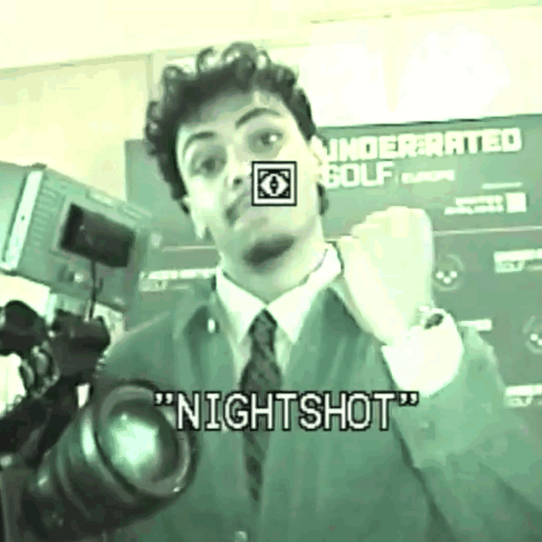 A person in a school uniform making a playful face at the camera, with the word "NIGHTSHOT" overlaid, and a sign in the background that says "UNDERGRATED GOLF".