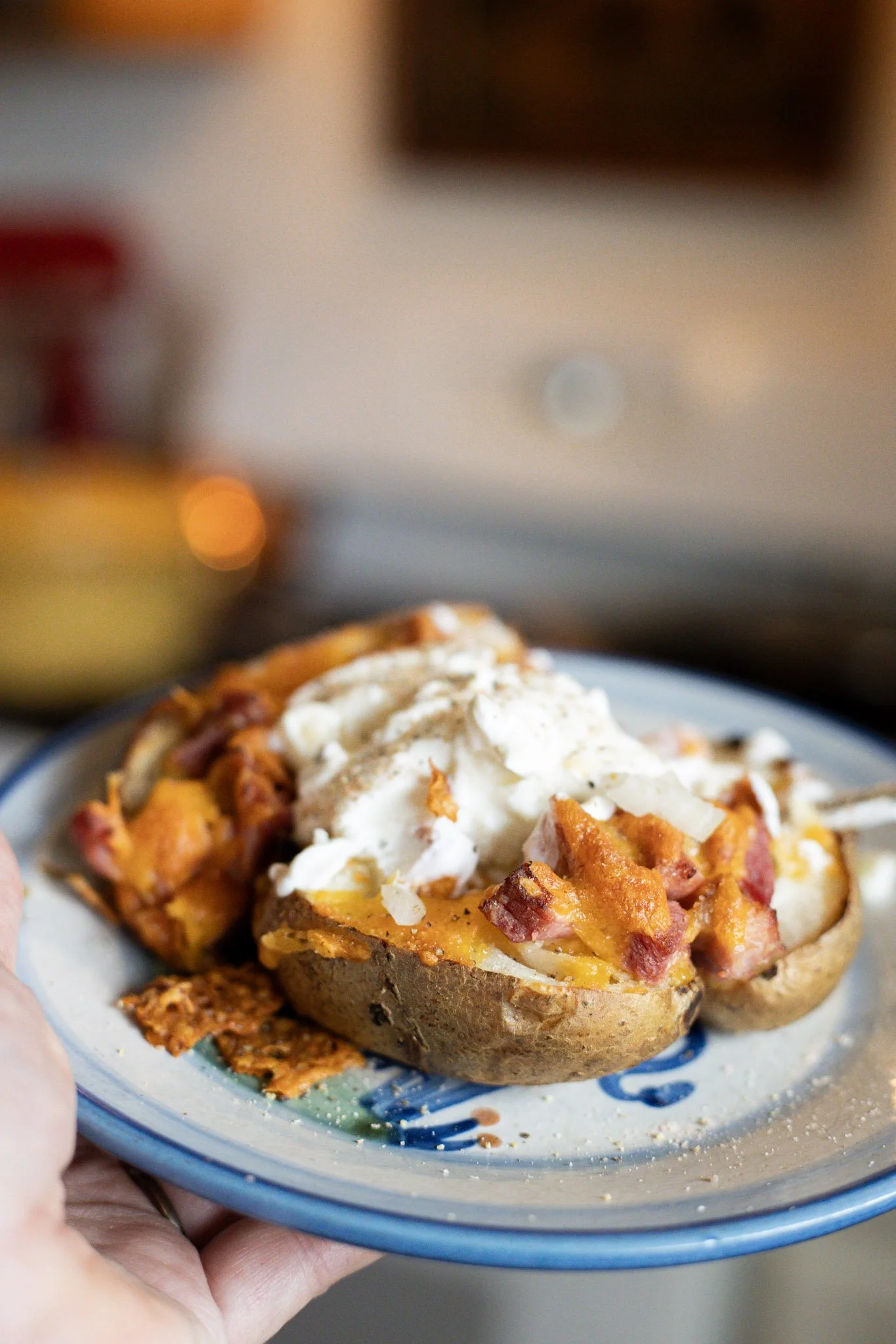 a loaded baked potato on a blue plate