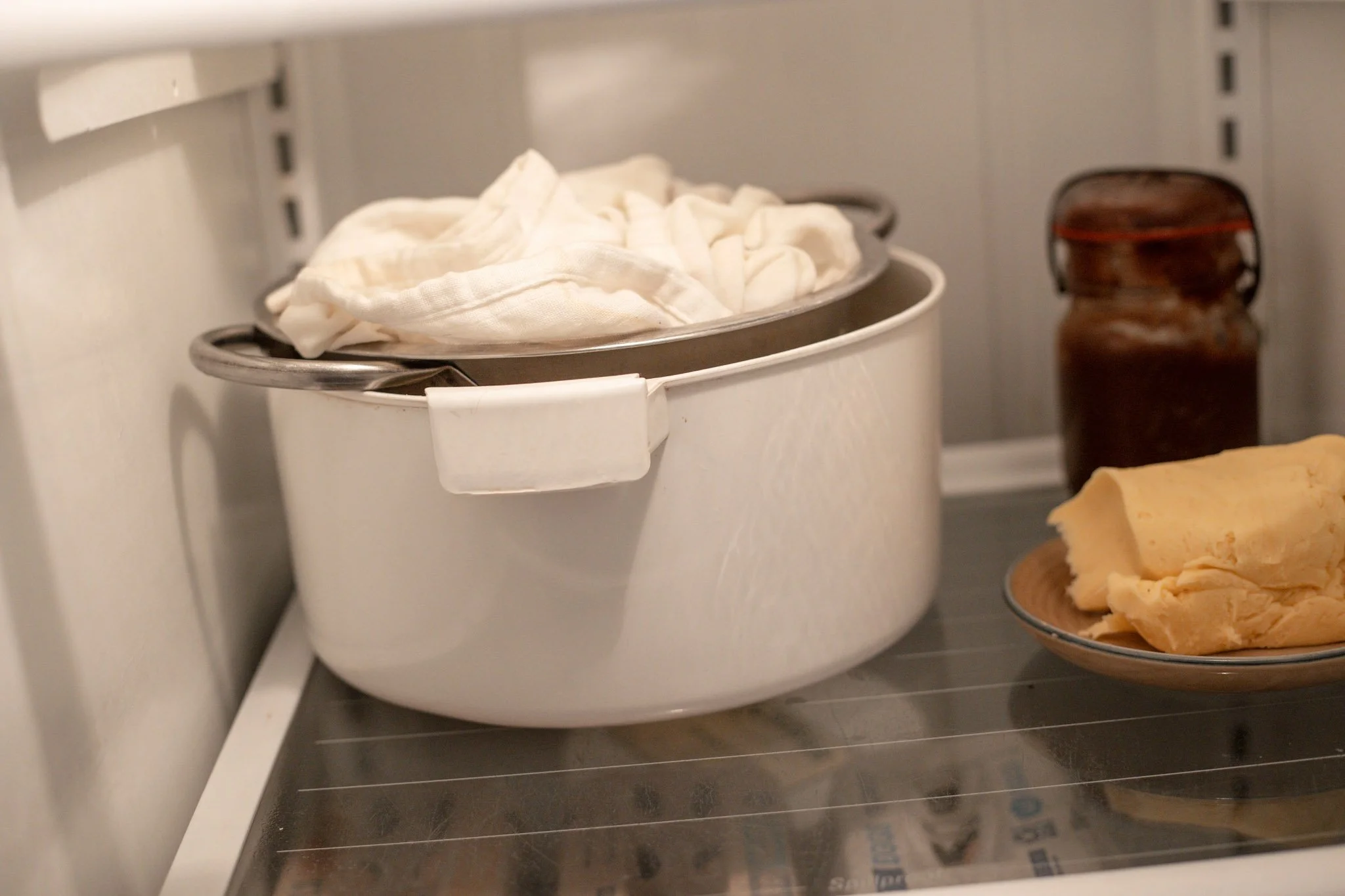 yogurt straining in a refrigerator