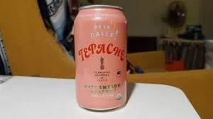 this is an image of a pink can on a table in someones little house