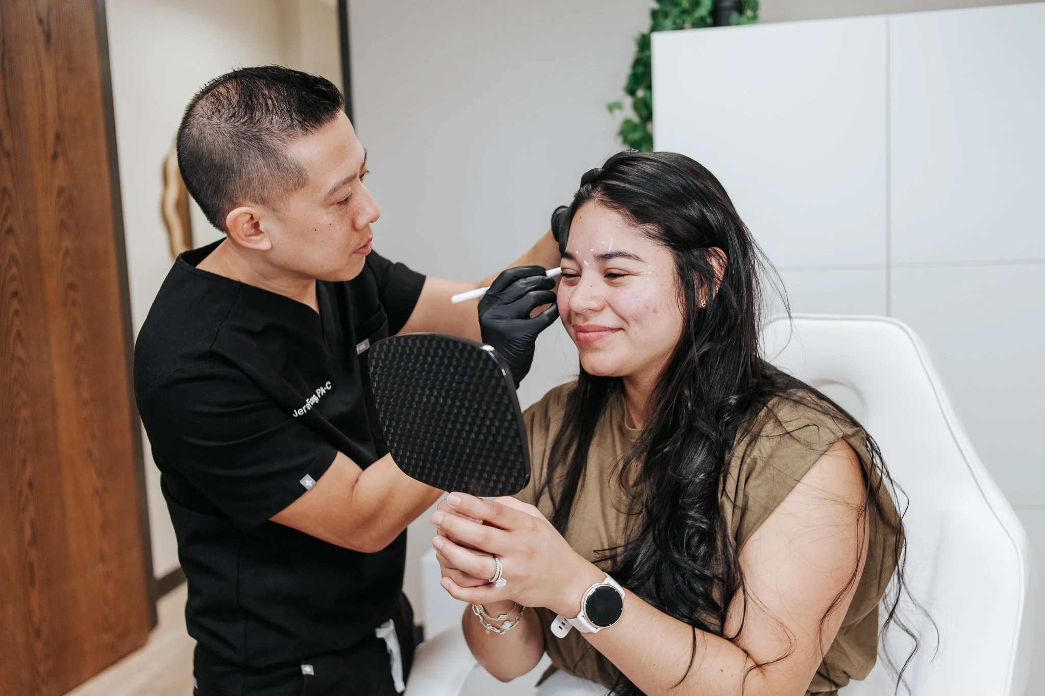 Jeremy Fong, PA-C preparing a woman's face for Botox treatment in Cypress, TX
