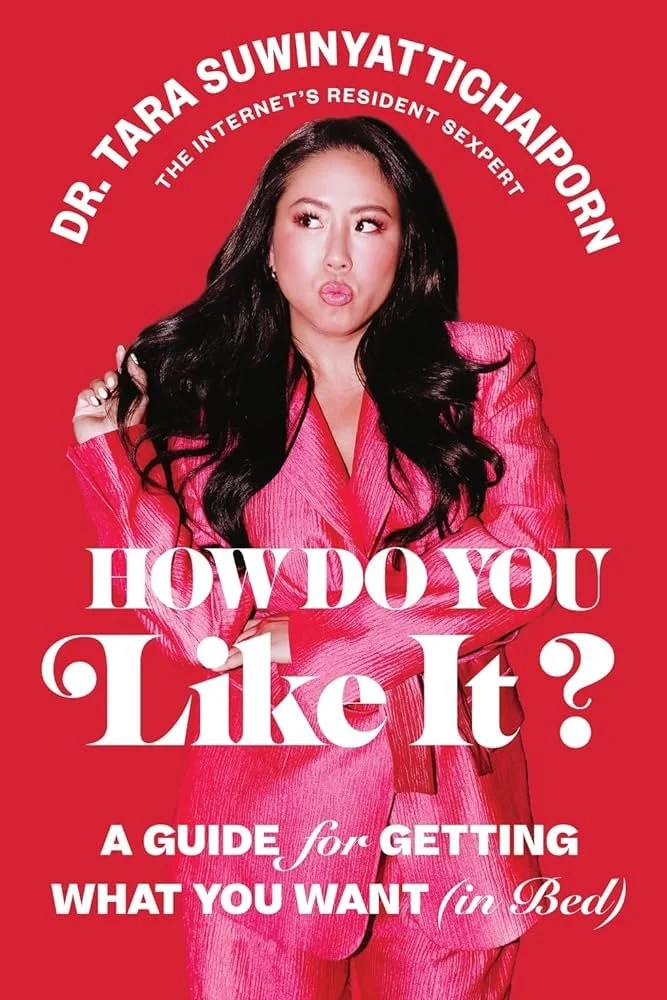Book cover featuring a woman in a pink suit, with long black hair, making a surprised pose. The text reads: "Dr. Tara Suwinyattichaiporn, The Internet's Resident Sexpert, How Do You Like It? A Guide for Getting What You Want in Bed."