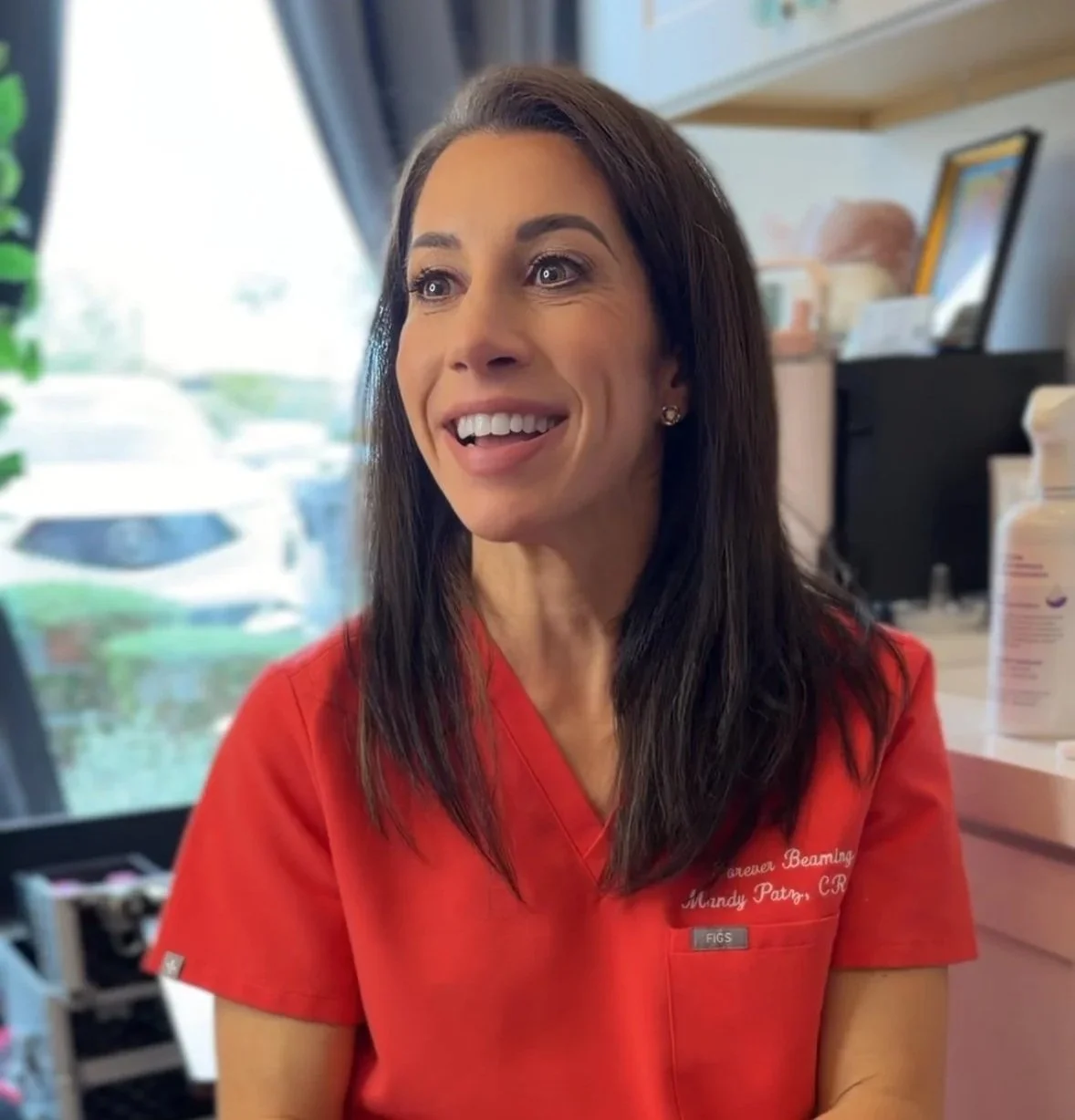 Mandy Patz-Beam, owner of Phoenix, AZ med spa Forever Beaming, smiling and looking to the left.