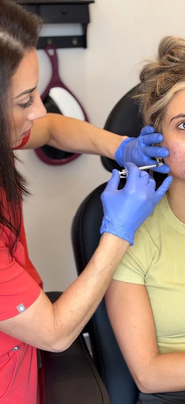 Mandy Patz-Beam administering a dermal filler treatment to a woman's jaw area.