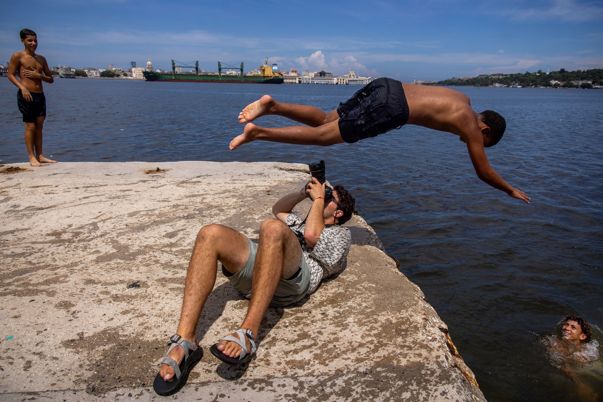 A photographer captures a diver above the waterfront in Cuba. Photograph by Ethan Swope.