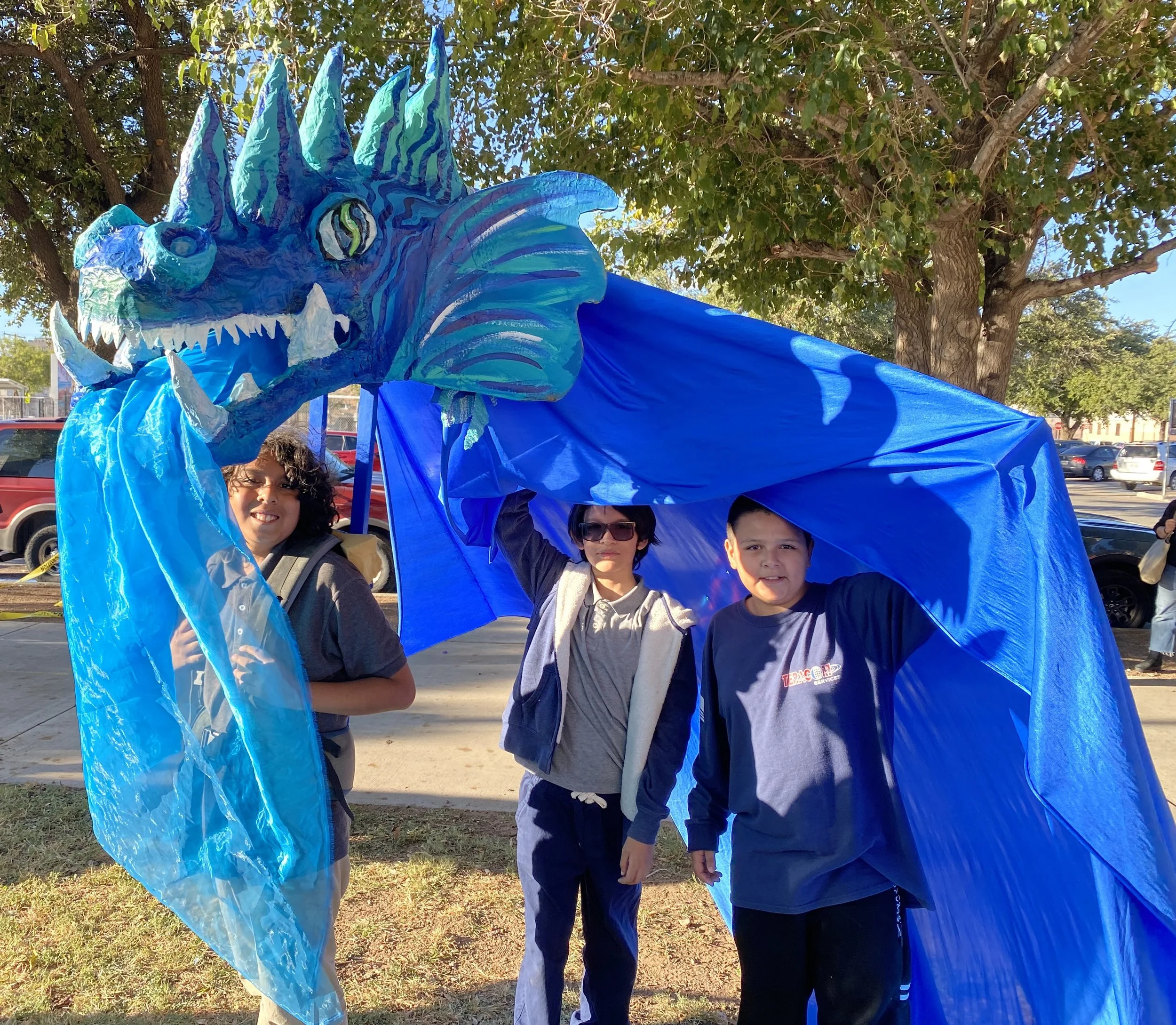 Youth perform with Water Dragon puppet created in community art builds.