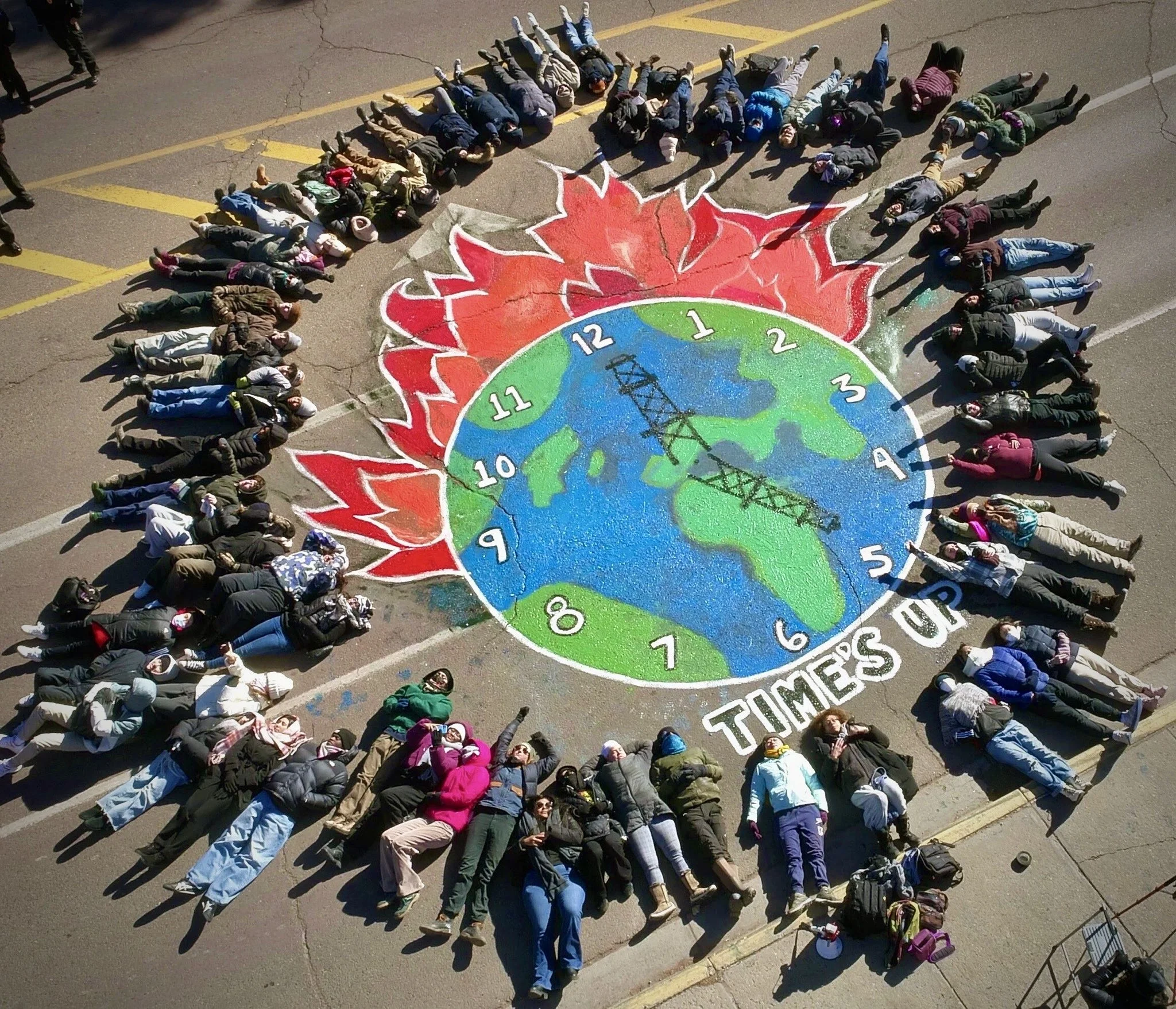 Time's Up, climate justice street mural by Youth United for Climate Crisis Action painted on the street in front of the New Mexico Roundhouse on the opening day of the legislative session 2025.