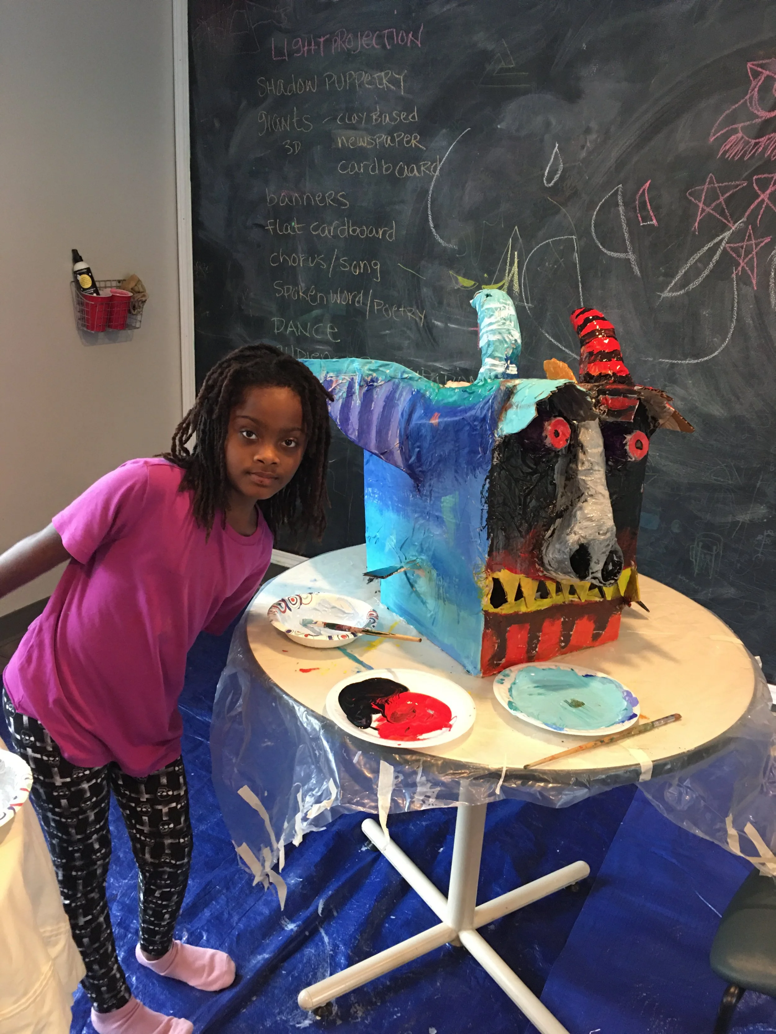 Boxhead dragon created by youth at Motherful resource center for single mamas as part of an outdoor community theater project.