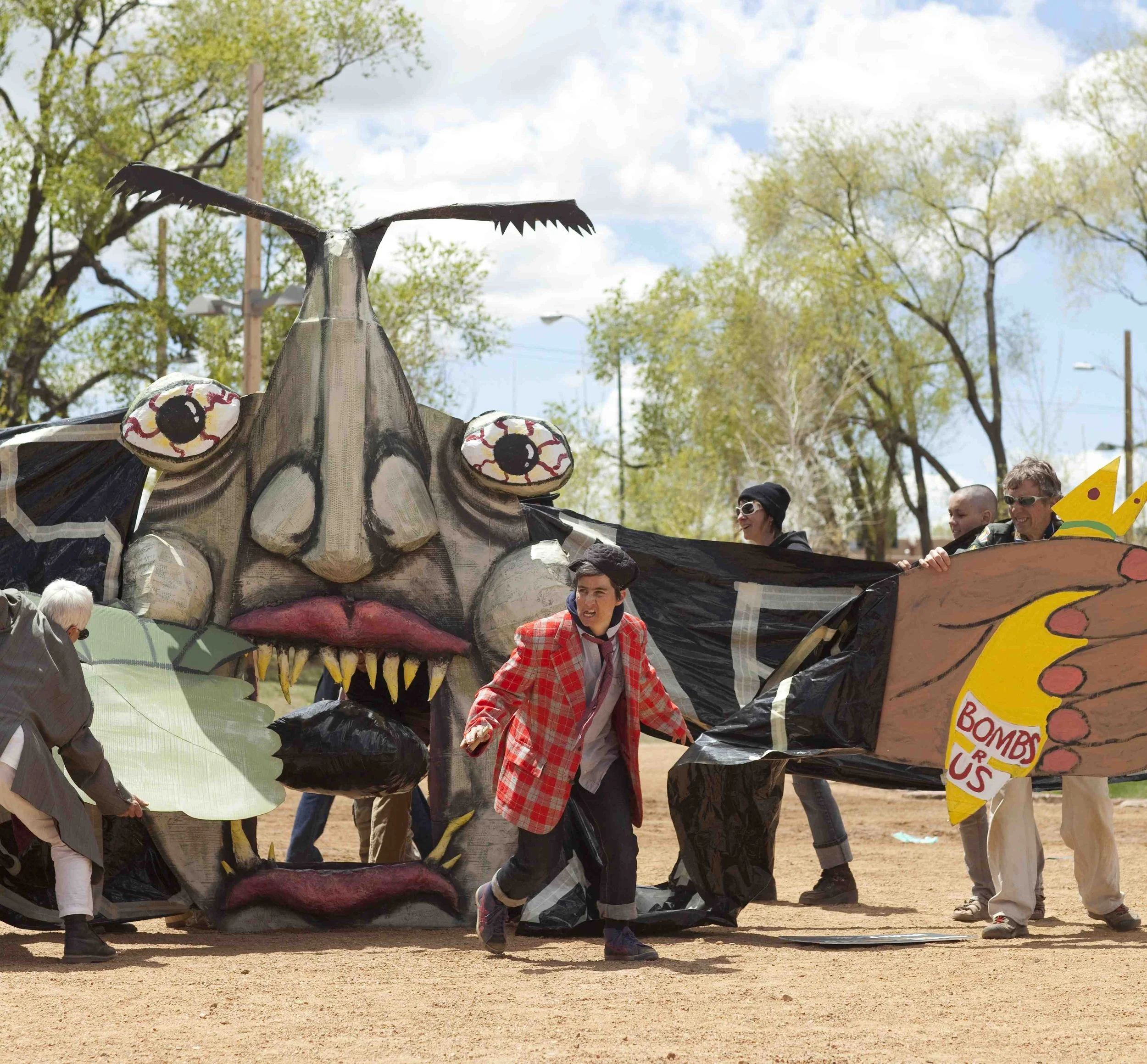 Corporate Person puppet insatiably eats everything good in the world at IGNITE street theatre event, Santa Fe, NM, 2010.